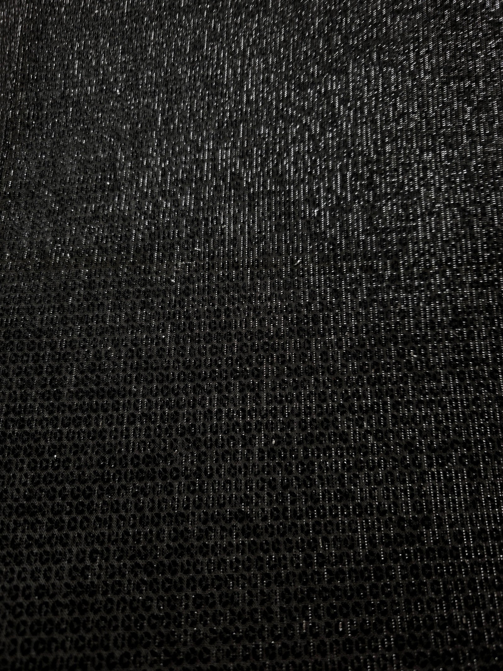 Close-up of Charcoal Silver Sheer Circle Shimmer Stretch Tulle Fabric revealing the circular shimmer repeat and fine sheer mesh