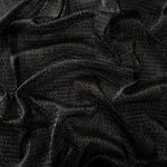 Draped Charcoal Silver Sheer Circle Shimmer Stretch Tulle Fabric showing reflective round motifs across soft fluid folds