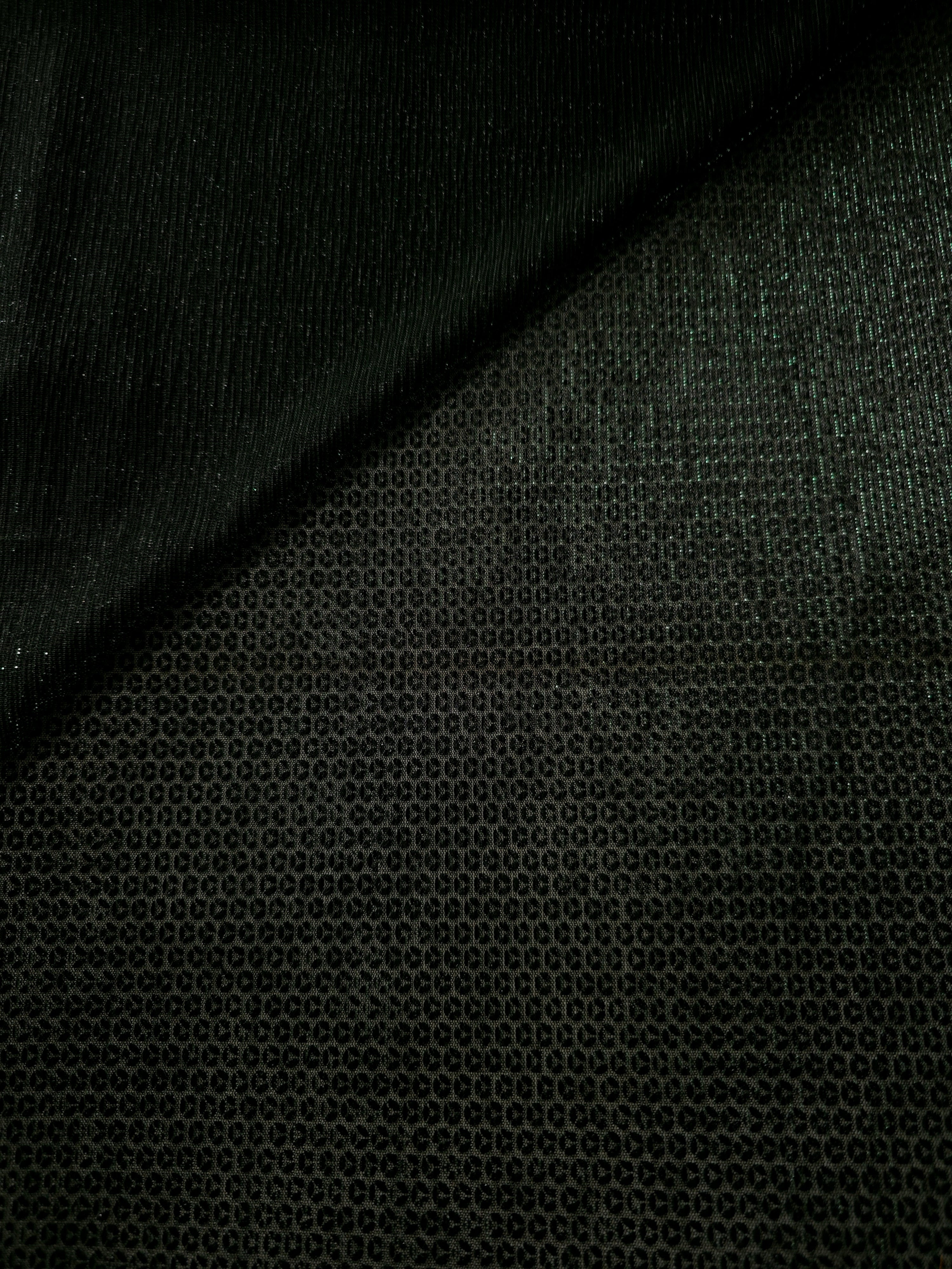 Front and back of Deep Emerald Sheer Circle Shimmer Stretch Tulle Fabric showing transparent knit structure, circle motif and stretch