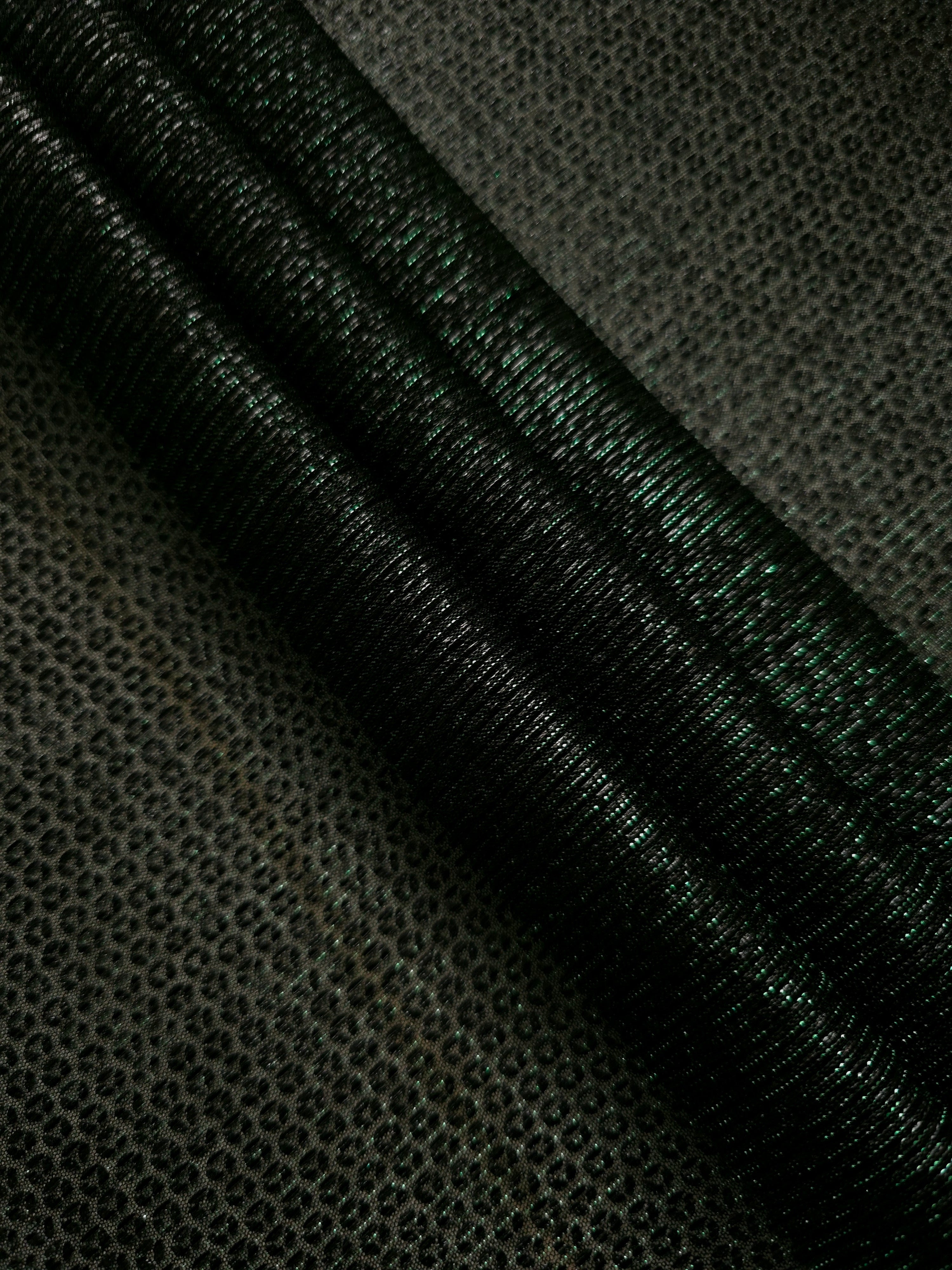 Layered Deep Emerald Sheer Circle Shimmer Stretch Tulle Fabric showing overlapping circles, luminous depth and airy transparency
