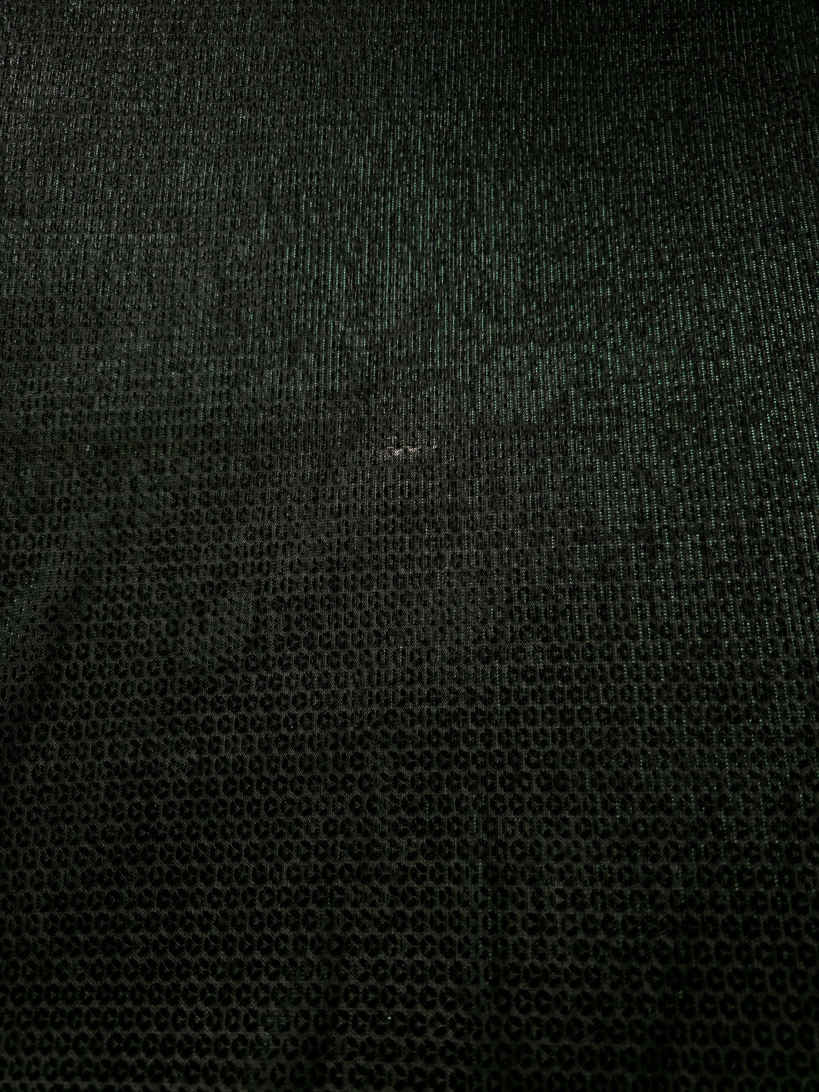 Surface detail of Deep Emerald Sheer Circle Shimmer Stretch Tulle Fabric highlighting reflective circle scale and lightweight tulle texture
