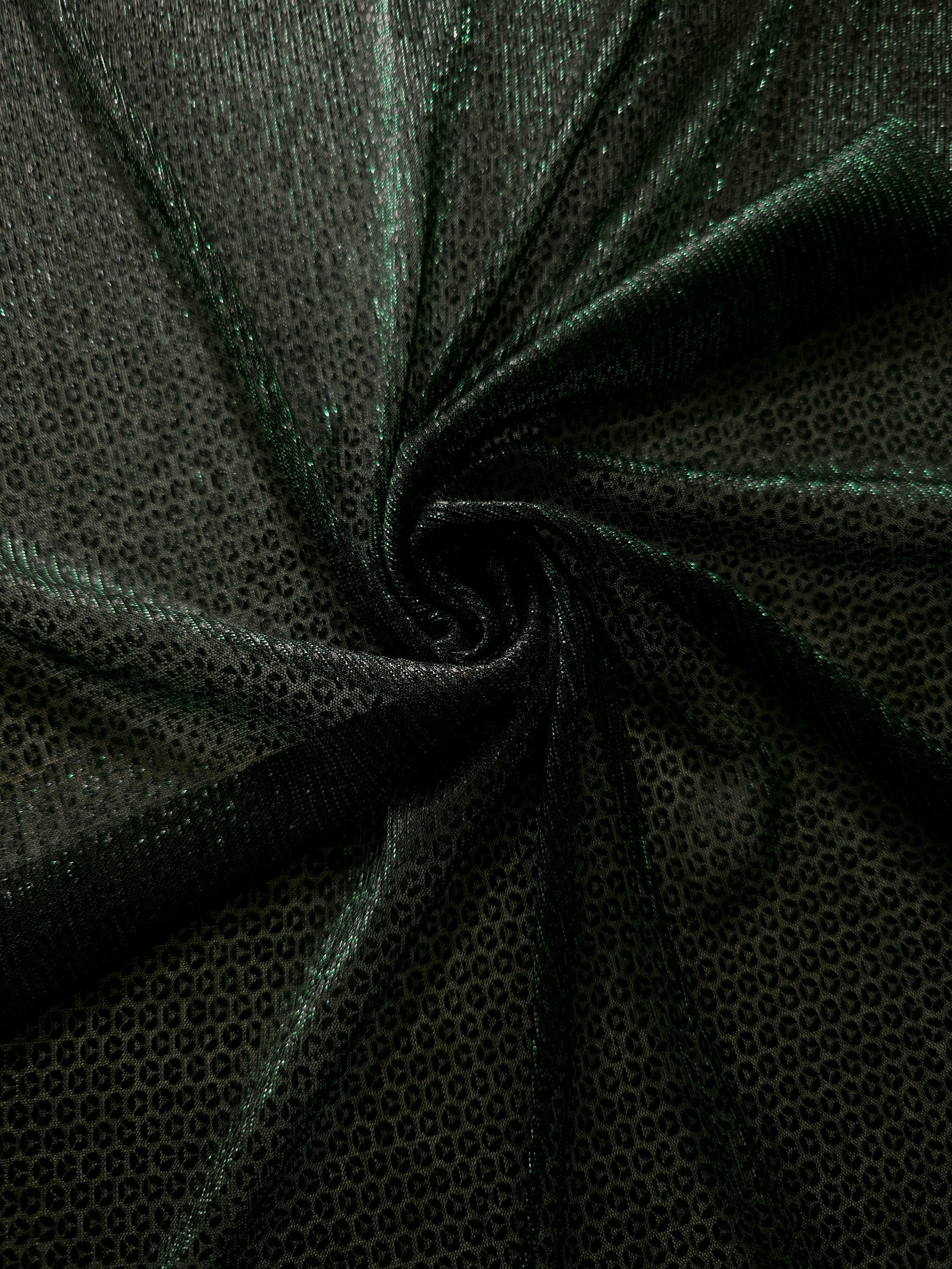 Swirl-draped Deep Emerald Sheer Circle Shimmer Stretch Tulle Fabric showing circular highlights shifting through flexible movement