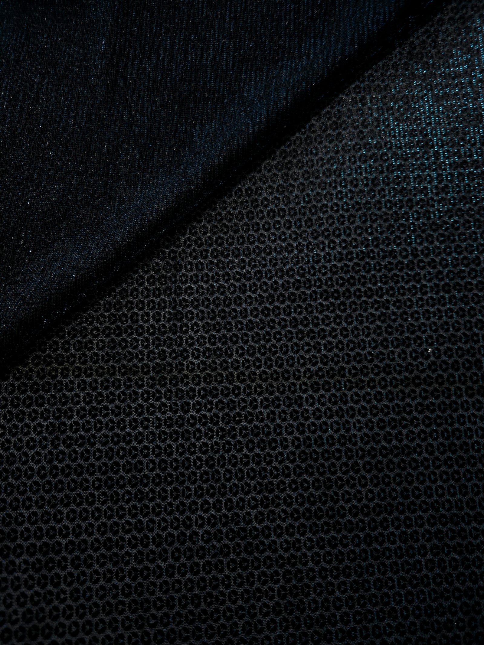 Close-up of Deep Teal Sheer Circle Shimmer Stretch Tulle Fabric revealing the circular shimmer repeat and fine sheer mesh