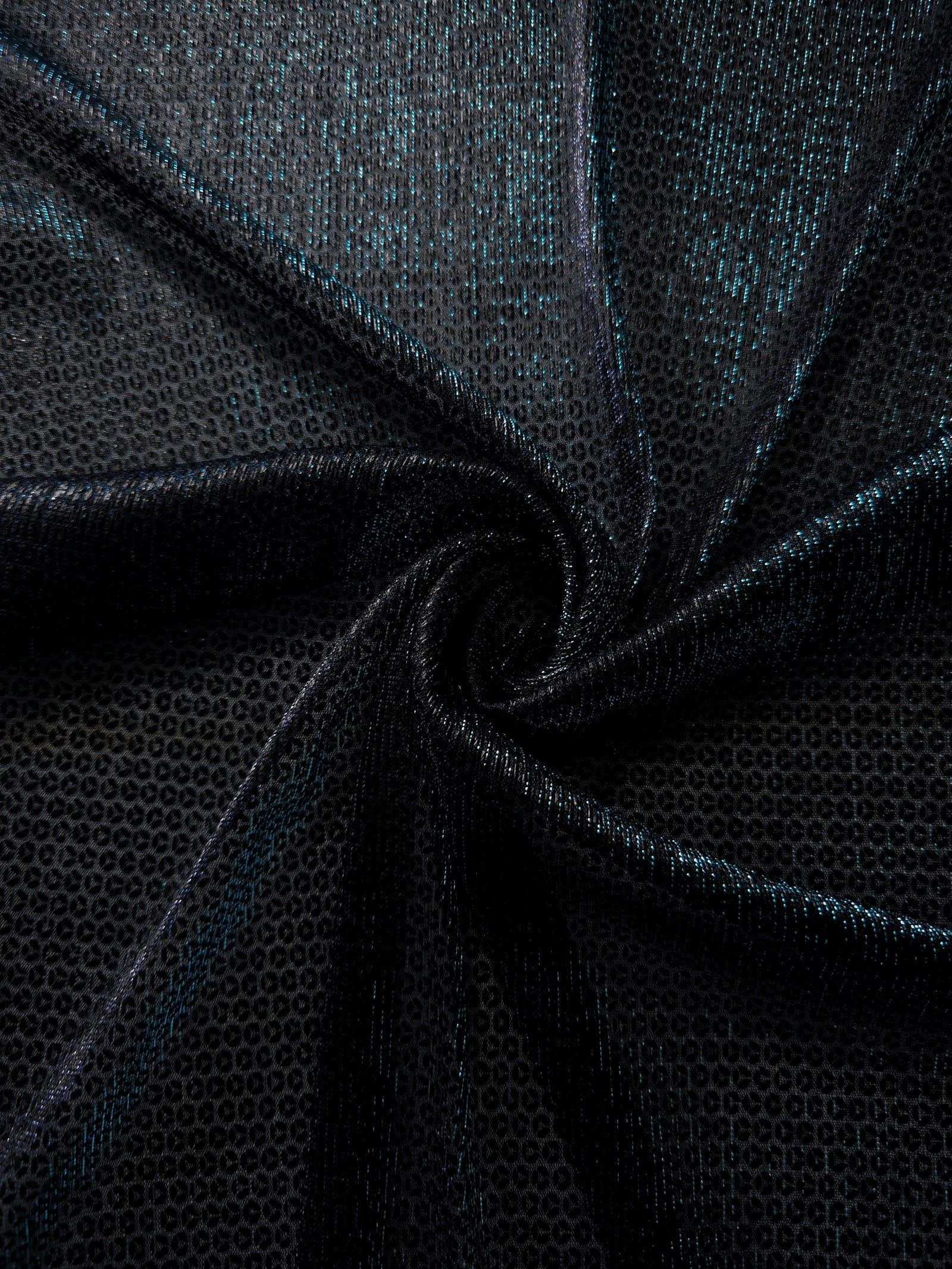 Draped Deep Teal Sheer Circle Shimmer Stretch Tulle Fabric showing reflective round motifs across soft fluid folds