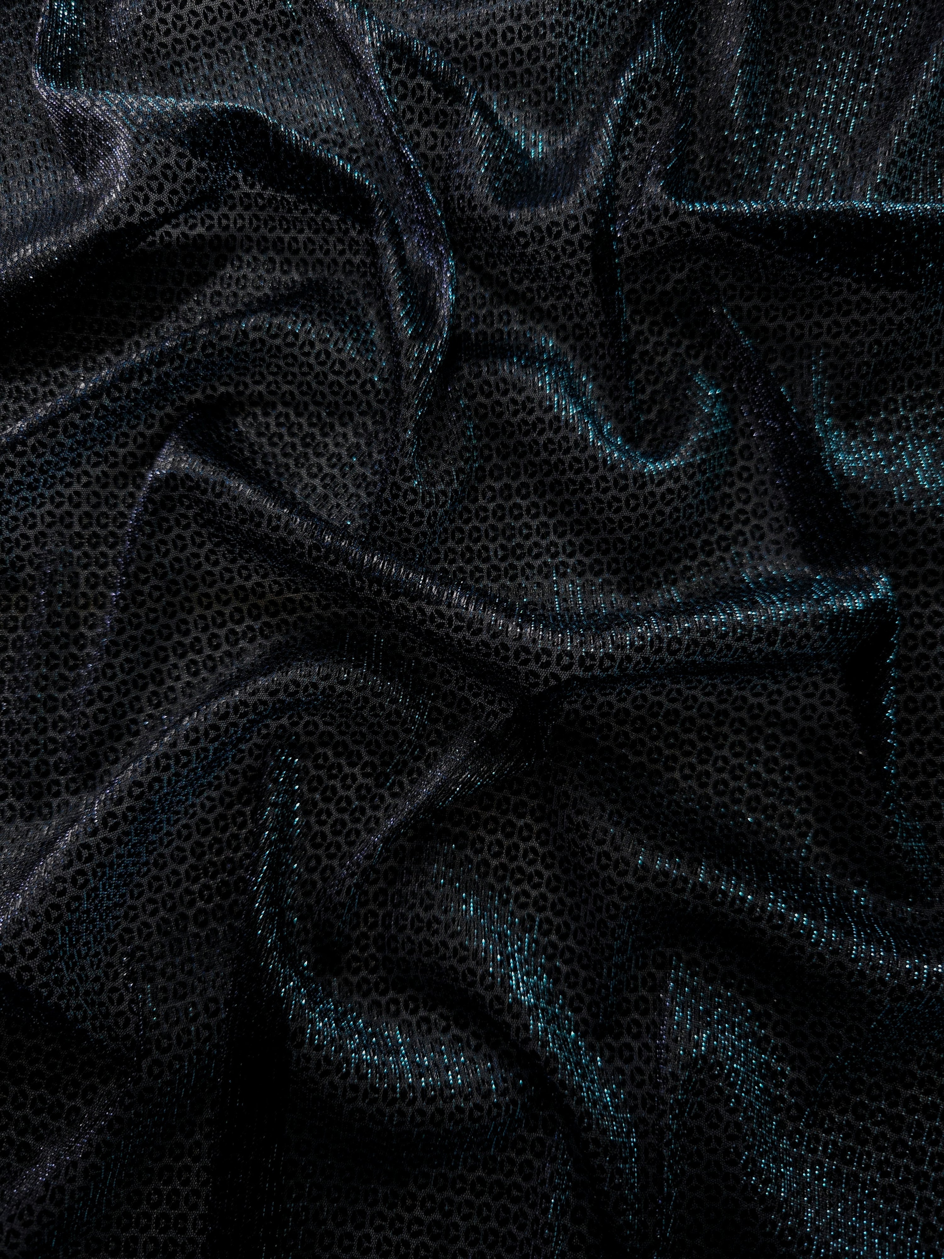 Front and back of Deep Teal Sheer Circle Shimmer Stretch Tulle Fabric showing transparent knit structure, circle motif and stretch