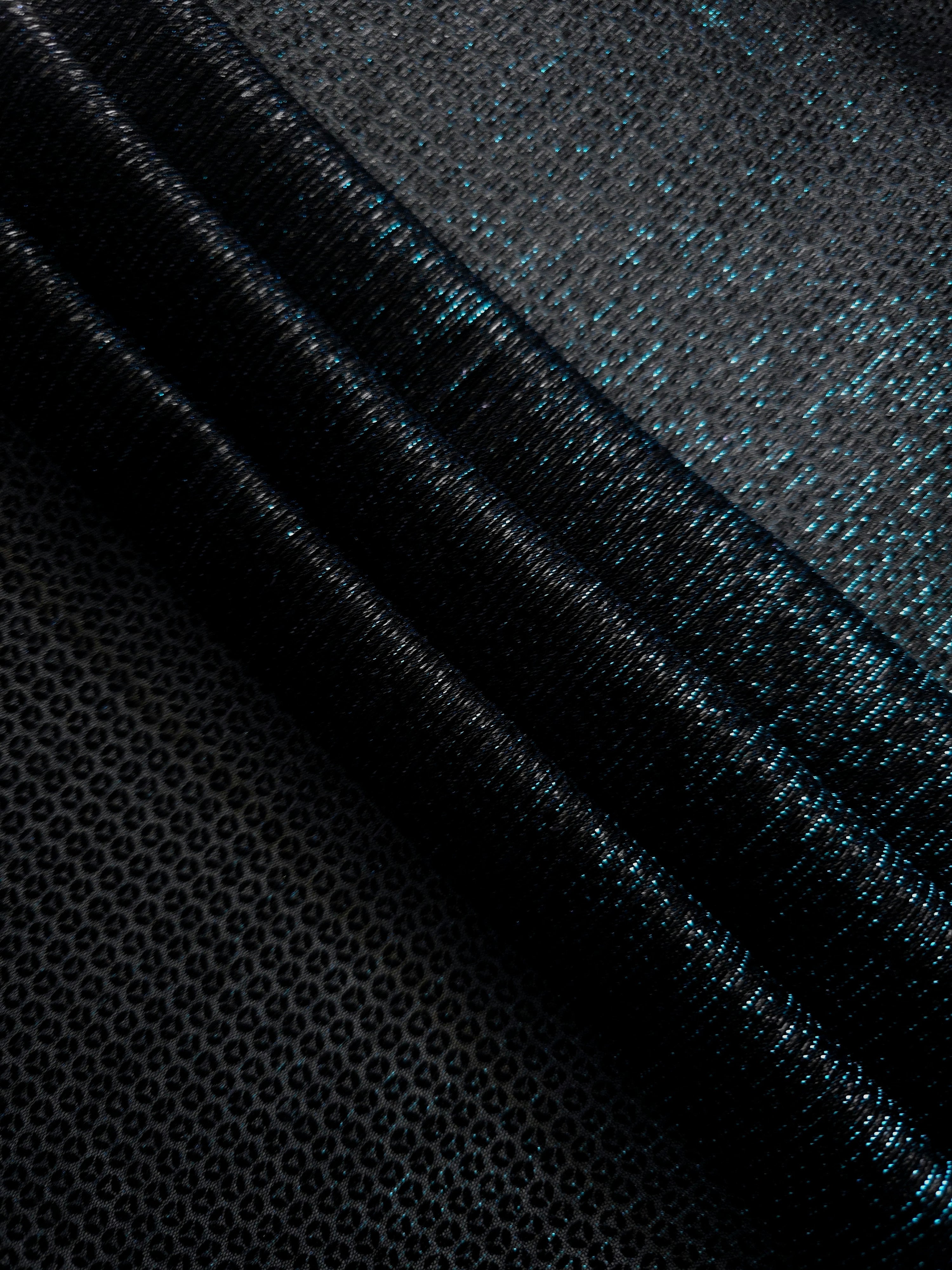 Swirl-draped Deep Teal Sheer Circle Shimmer Stretch Tulle Fabric showing circular highlights shifting through flexible movement