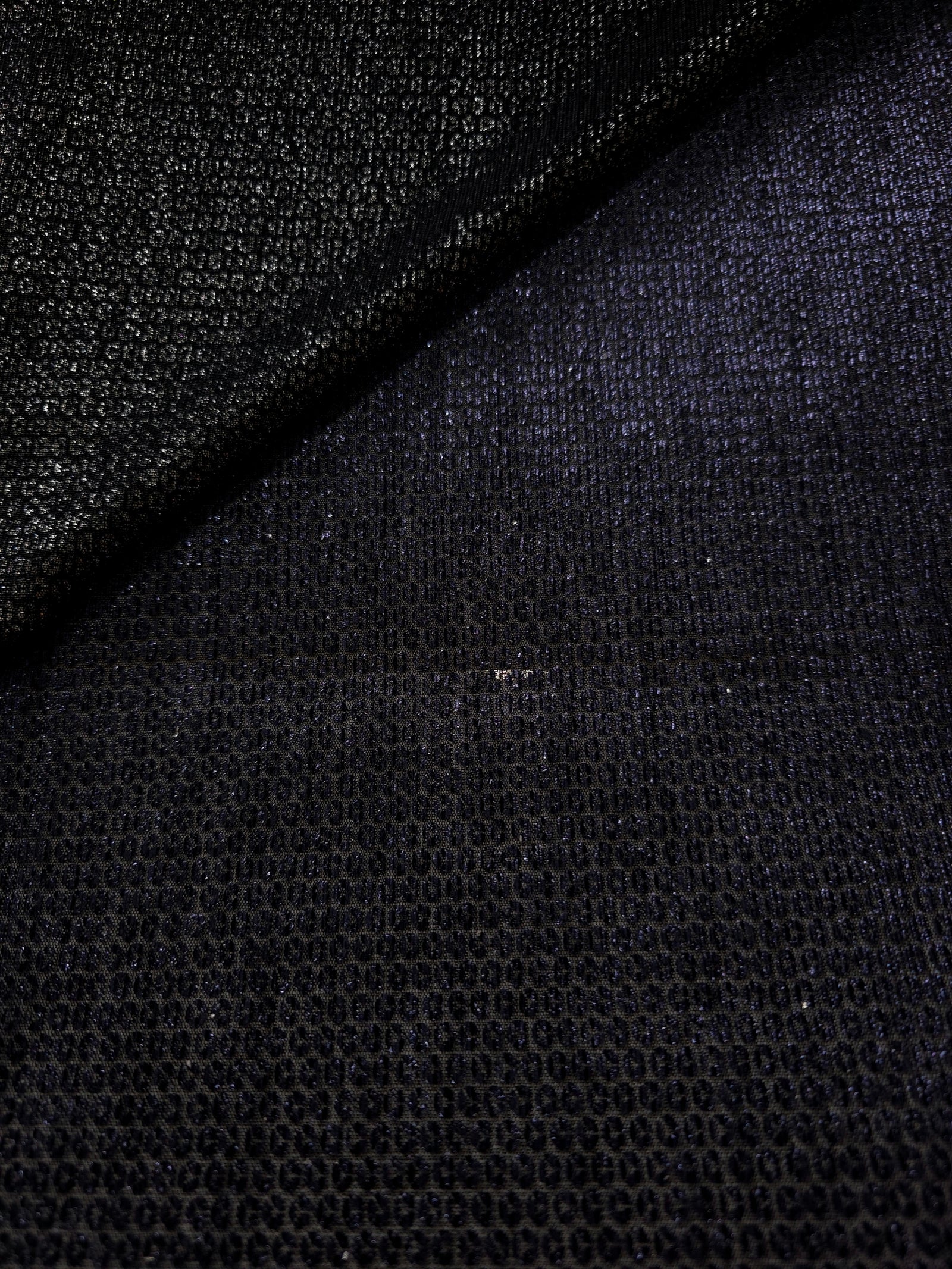 Close-up of Midnight Indigo Sheer Circle Shimmer Stretch Tulle Fabric revealing the circular shimmer repeat and fine sheer mesh