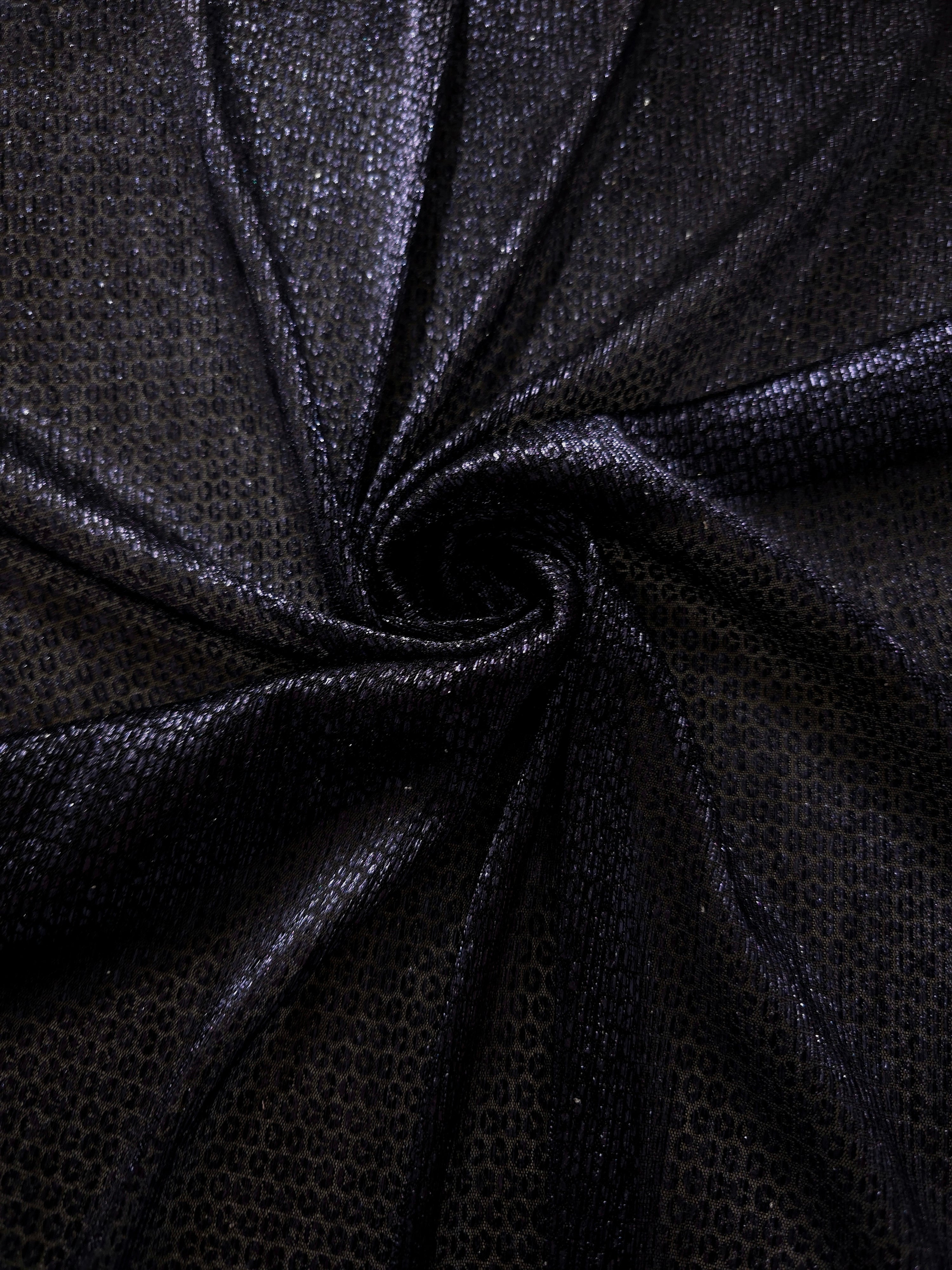Draped Midnight Indigo Sheer Circle Shimmer Stretch Tulle Fabric showing reflective round motifs across soft fluid folds