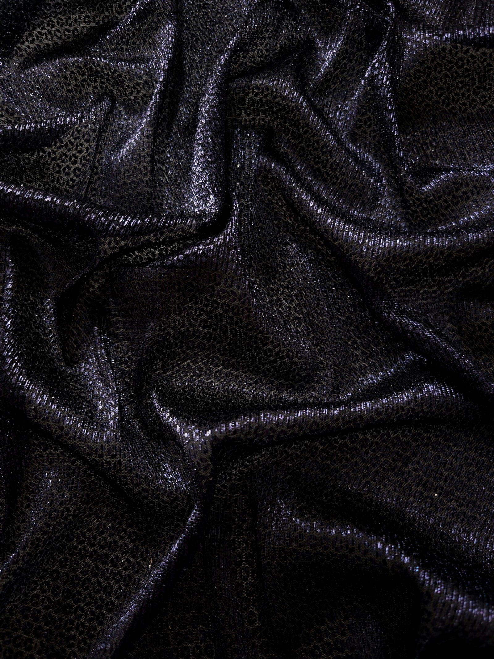 Front and back of Midnight Indigo Sheer Circle Shimmer Stretch Tulle Fabric showing transparent knit structure, circle motif and stretch