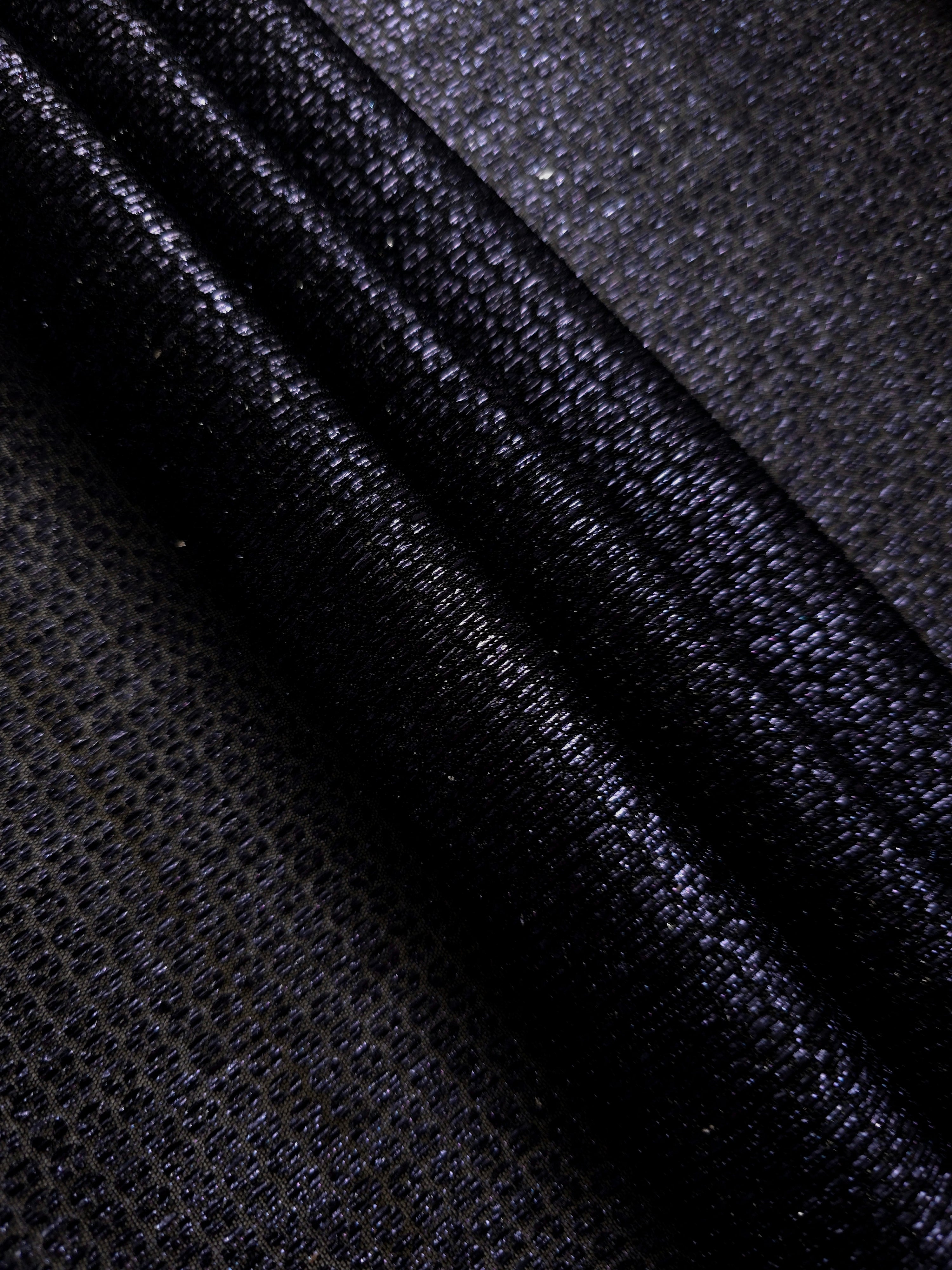 Swirl-draped Midnight Indigo Sheer Circle Shimmer Stretch Tulle Fabric showing circular highlights shifting through flexible movement