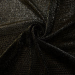 Swirl-draped Olive Gold Sheer Circle Shimmer Stretch Tulle Fabric showing circular highlights shifting through flexible movement