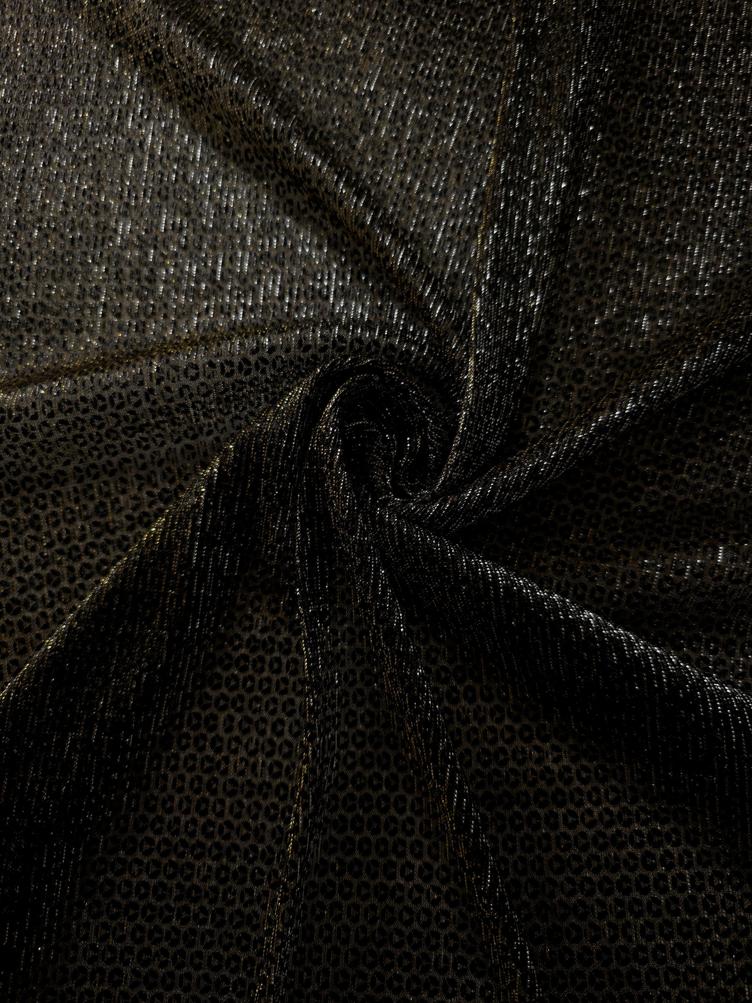 Swirl-draped Olive Gold Sheer Circle Shimmer Stretch Tulle Fabric showing circular highlights shifting through flexible movement