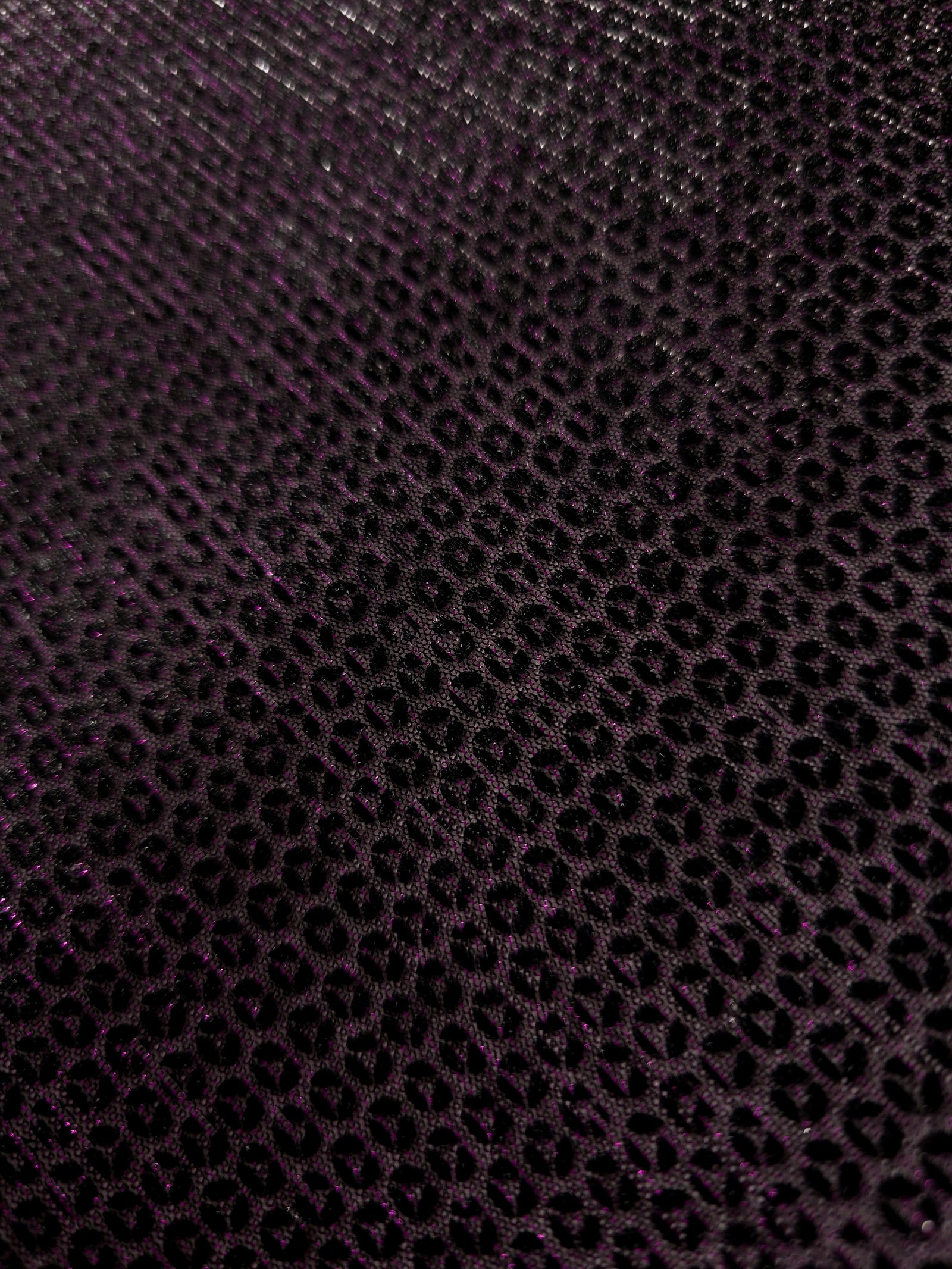 Close-up of Plum Violet Sheer Circle Shimmer Stretch Tulle Fabric revealing the circular shimmer repeat and fine sheer mesh