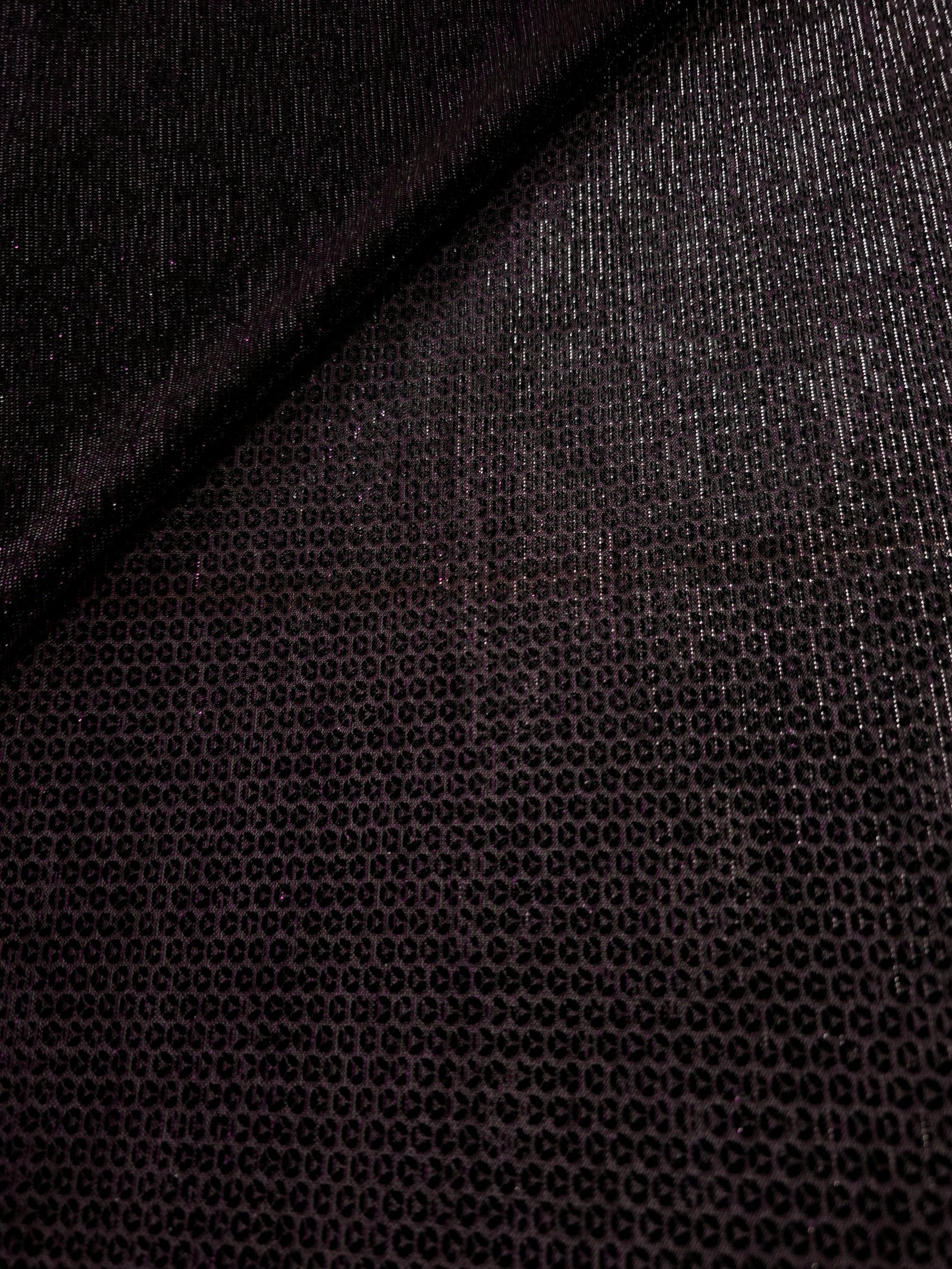 Front and back of Plum Violet Sheer Circle Shimmer Stretch Tulle Fabric showing transparent knit structure, circle motif and stretch