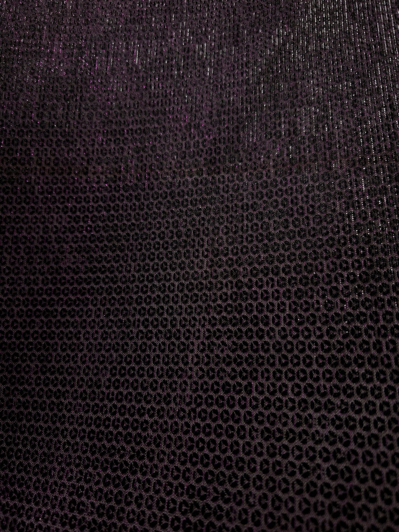 Surface detail of Plum Violet Sheer Circle Shimmer Stretch Tulle Fabric highlighting reflective circle scale and lightweight tulle texture