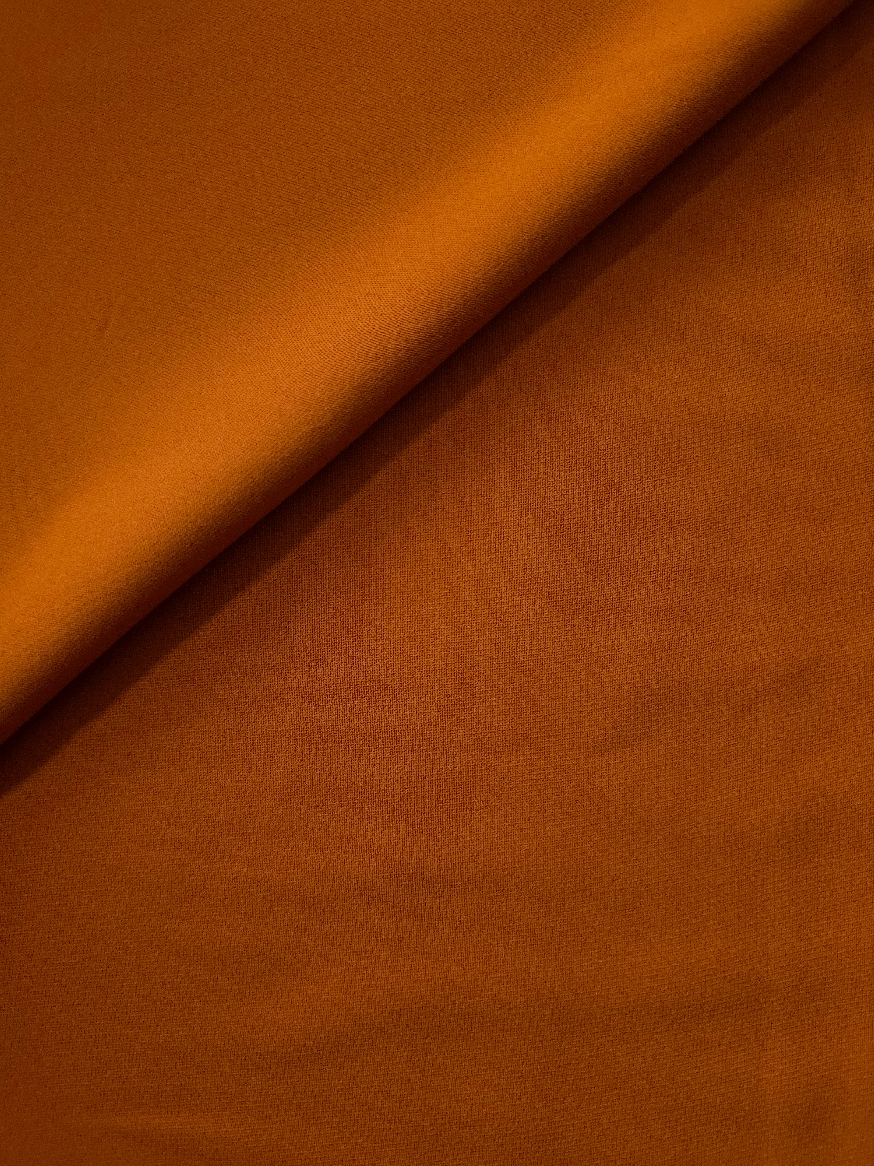 Cognac Brown Italian crepe in a soft fold, showing fluid drape for blouses, dresses and flowing skirts