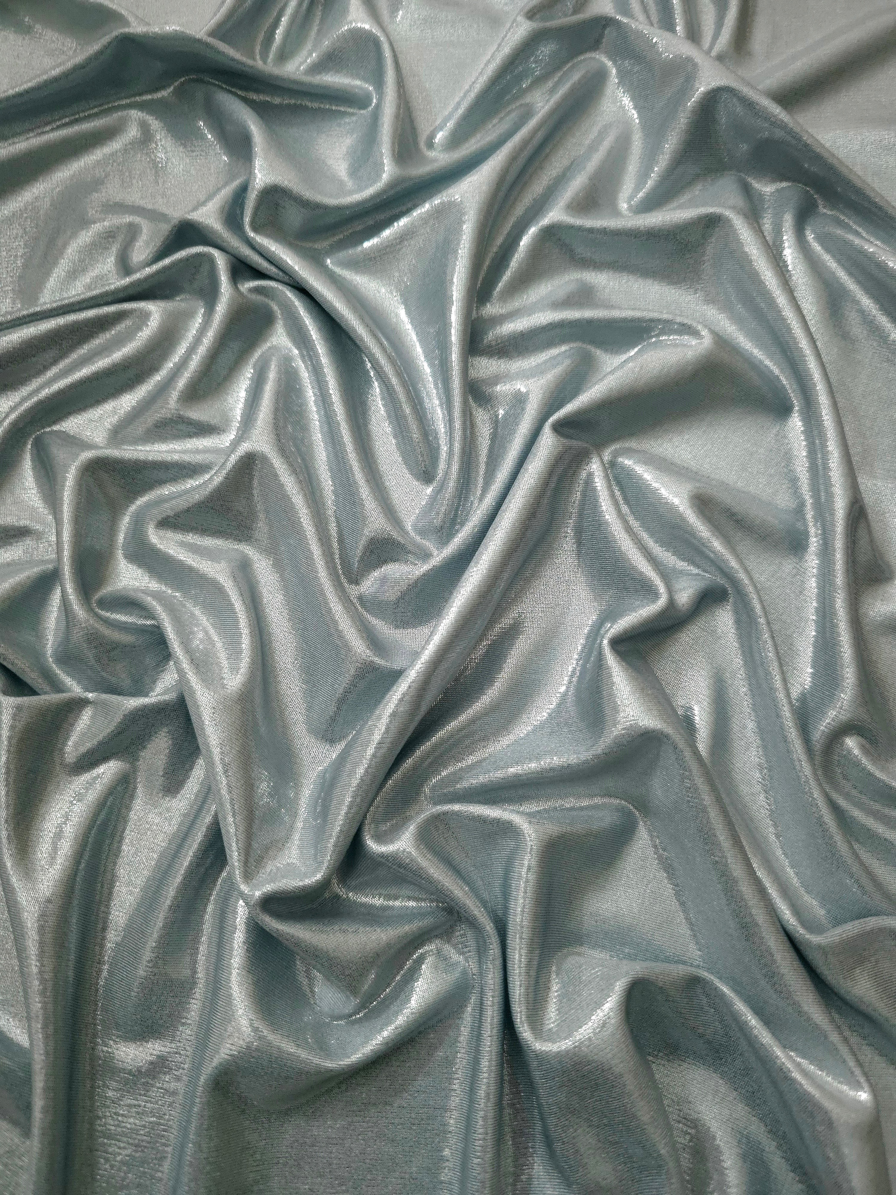 Cool Silver Gray metallic stretch fabric arranged in elegant folds, showing reflective movement for occasionwear, costumes and fashion design