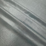 Layered Cool Silver Gray metallic stretch fabric with reflective foil finish, showing flexible body for dancewear and occasion fashion