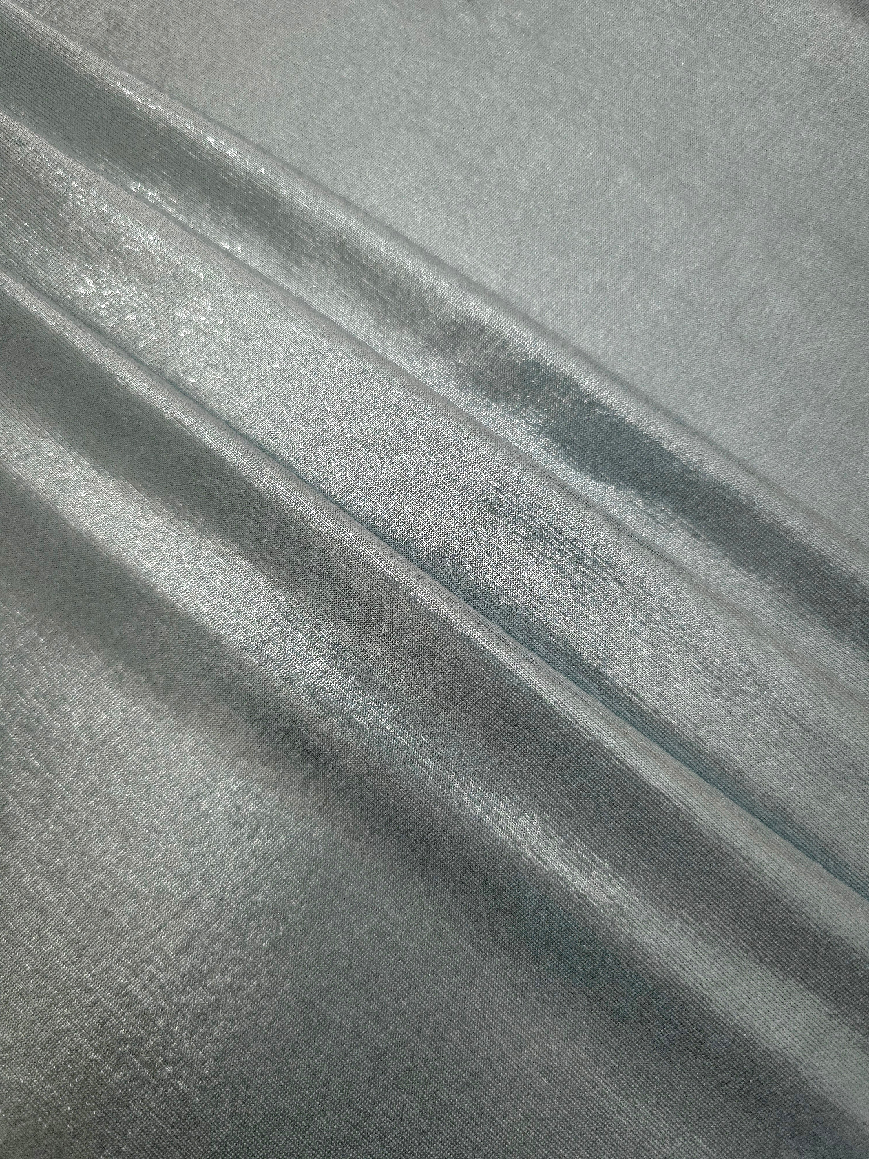 Layered Cool Silver Gray metallic stretch fabric with reflective foil finish, showing flexible body for dancewear and occasion fashion