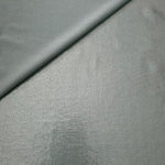 Cool Silver Gray metallic stretch fabric in a soft fold, revealing reflective drape for dancewear, dresses and statement apparel