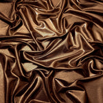 Draped Copper Brown metallic foiled spandex showing reflective folds and flexible flow for dresses, stagewear and occasion looks