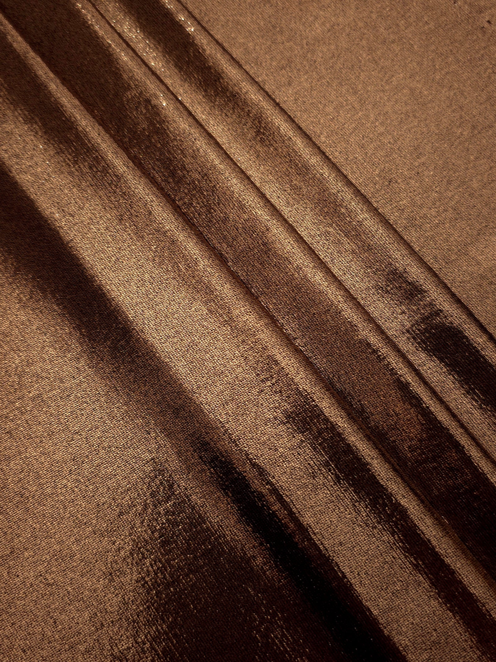 Layered Copper Brown shimmer stretch fabric showing metallic foil depth and soft structure for costumes, skirts and fashion apparel