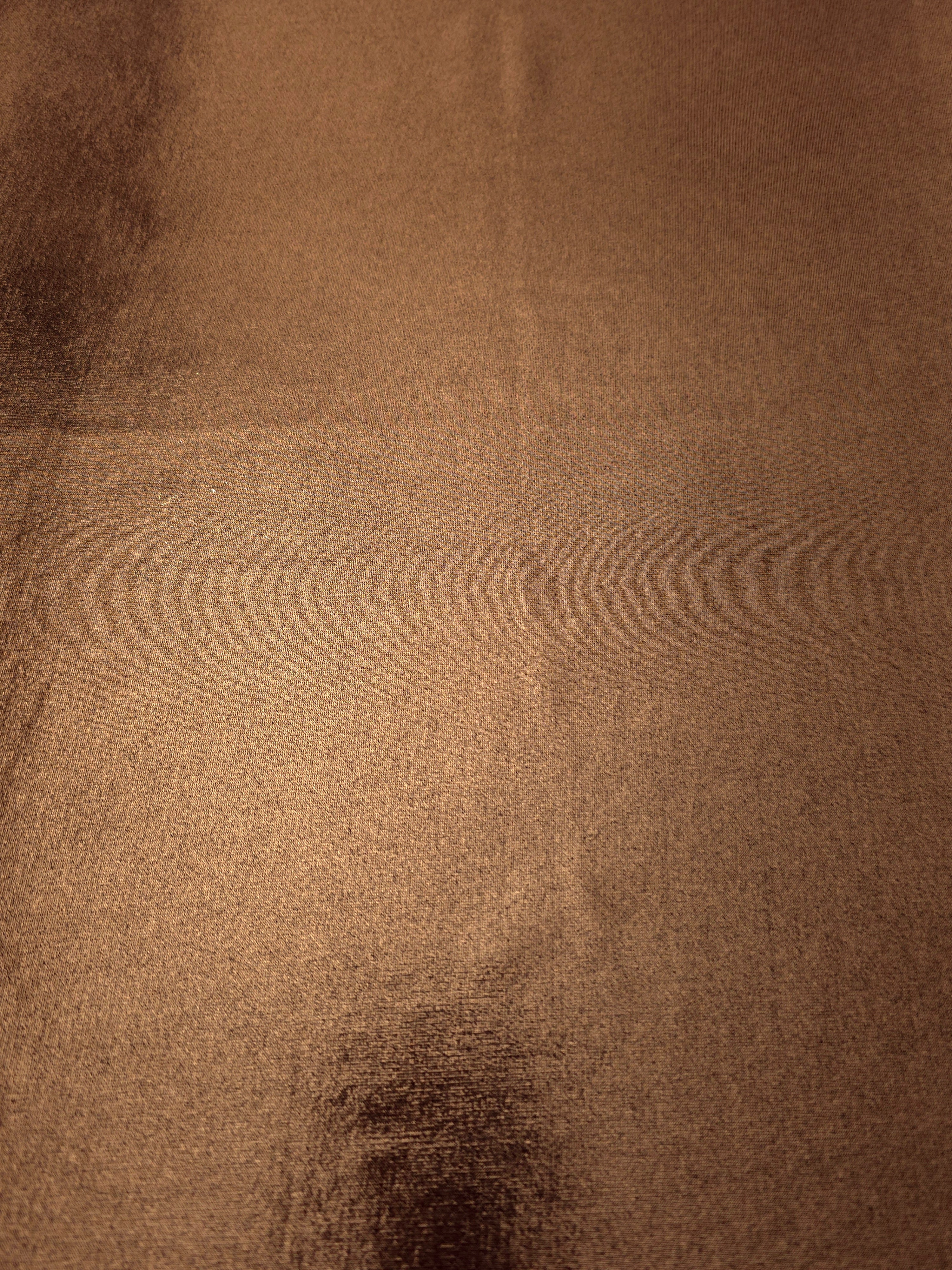 Copper Brown metallic foiled spandex shown flat, reflective stretch fabric for dancewear, eveningwear and statement garments