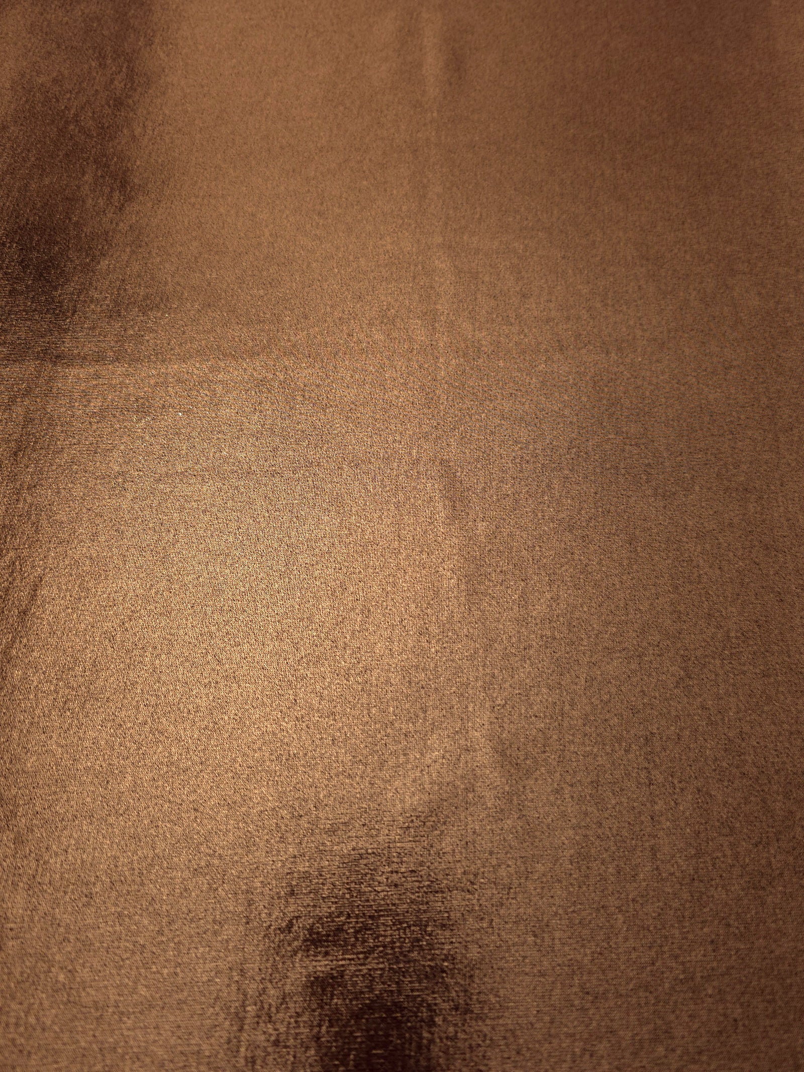 Copper Brown metallic foiled spandex shown flat, reflective stretch fabric for dancewear, eveningwear and statement garments