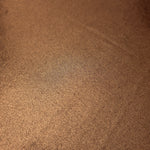 Close-up of Copper Brown metallic foiled spandex showing reflective surface texture and the detailed shimmer finish