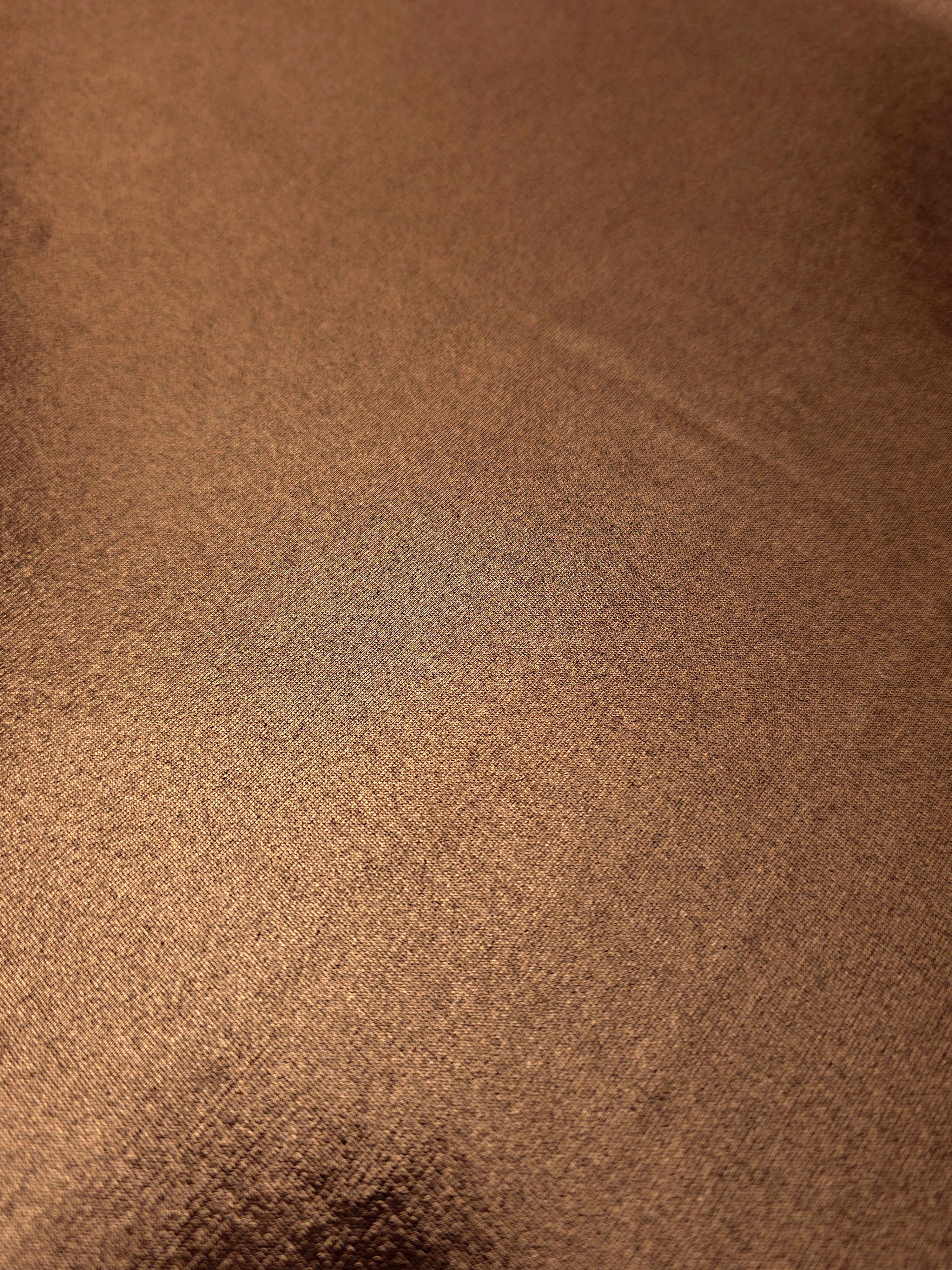 Close-up of Copper Brown metallic foiled spandex showing reflective surface texture and the detailed shimmer finish