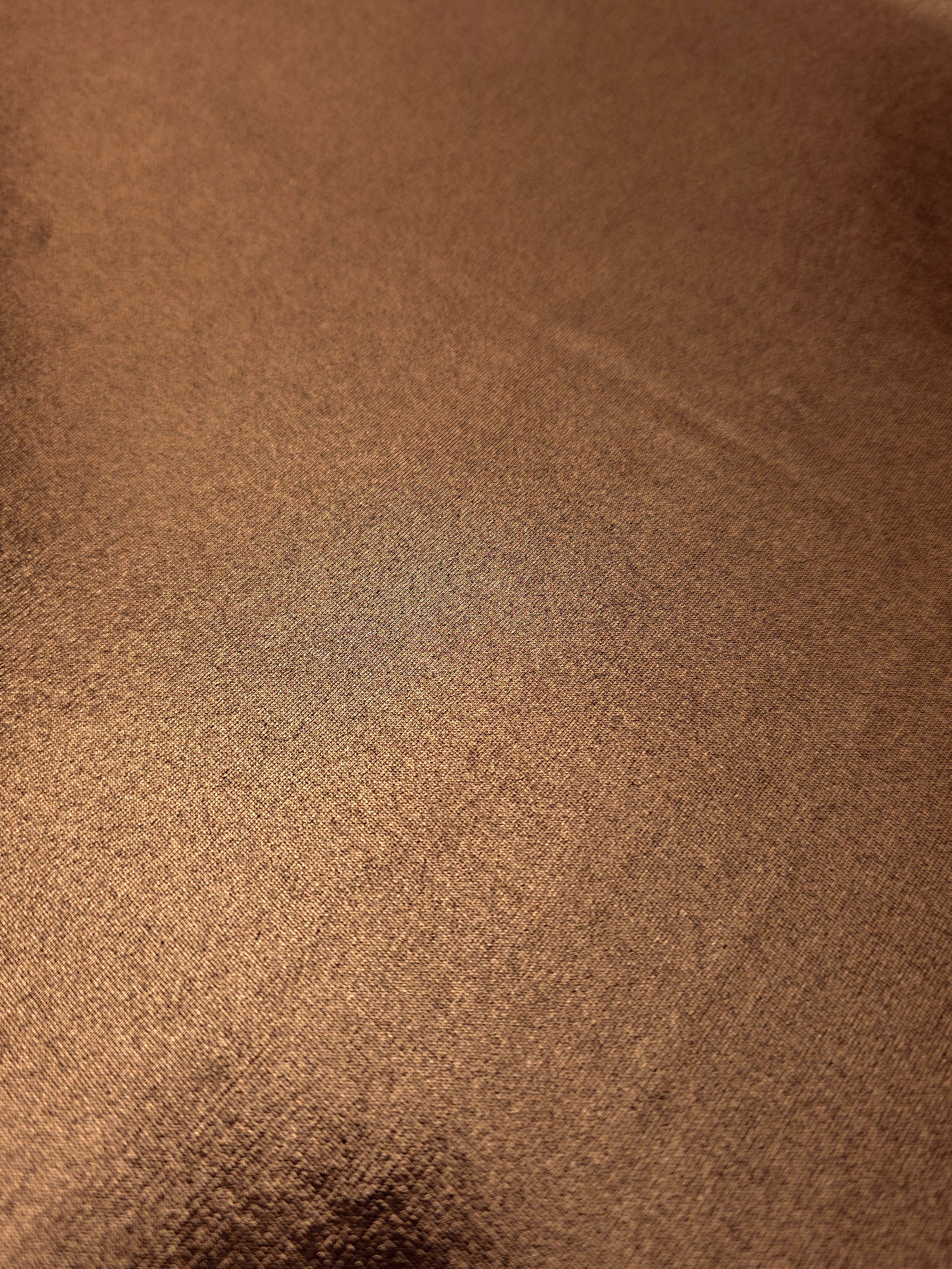 Close-up of Copper Brown metallic foiled spandex showing reflective surface texture and the detailed shimmer finish