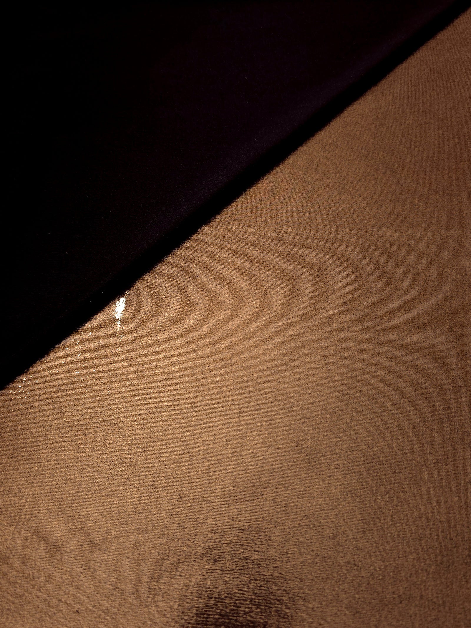 Copper Brown shimmer spandex in a soft fold, showing metallic foil sheen and flexible drape for tops, skirts and costumes