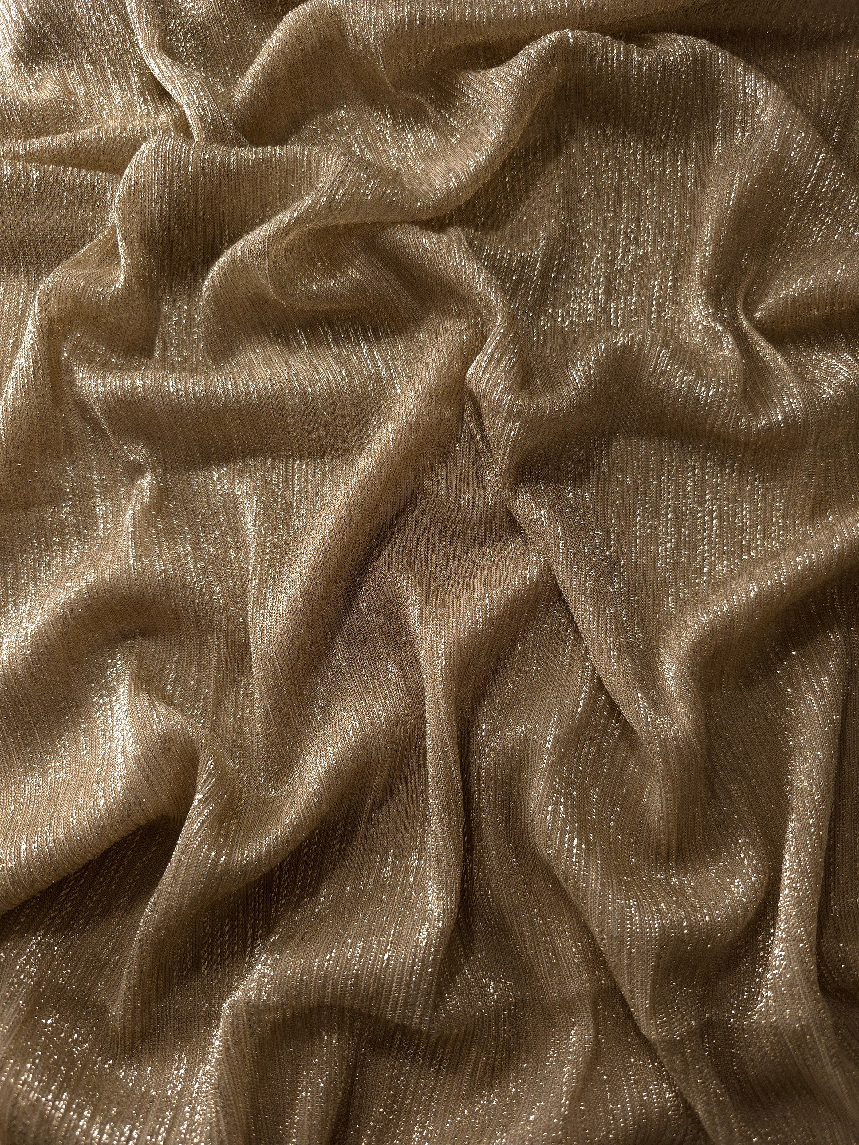 Draped Antique Taupe Gold Sheer Metallic Shimmer Stretch Tulle Fabric showing luminous reflective folds, soft transparency and flexible flow for dresses, dancewear, stagewear and occasion looks