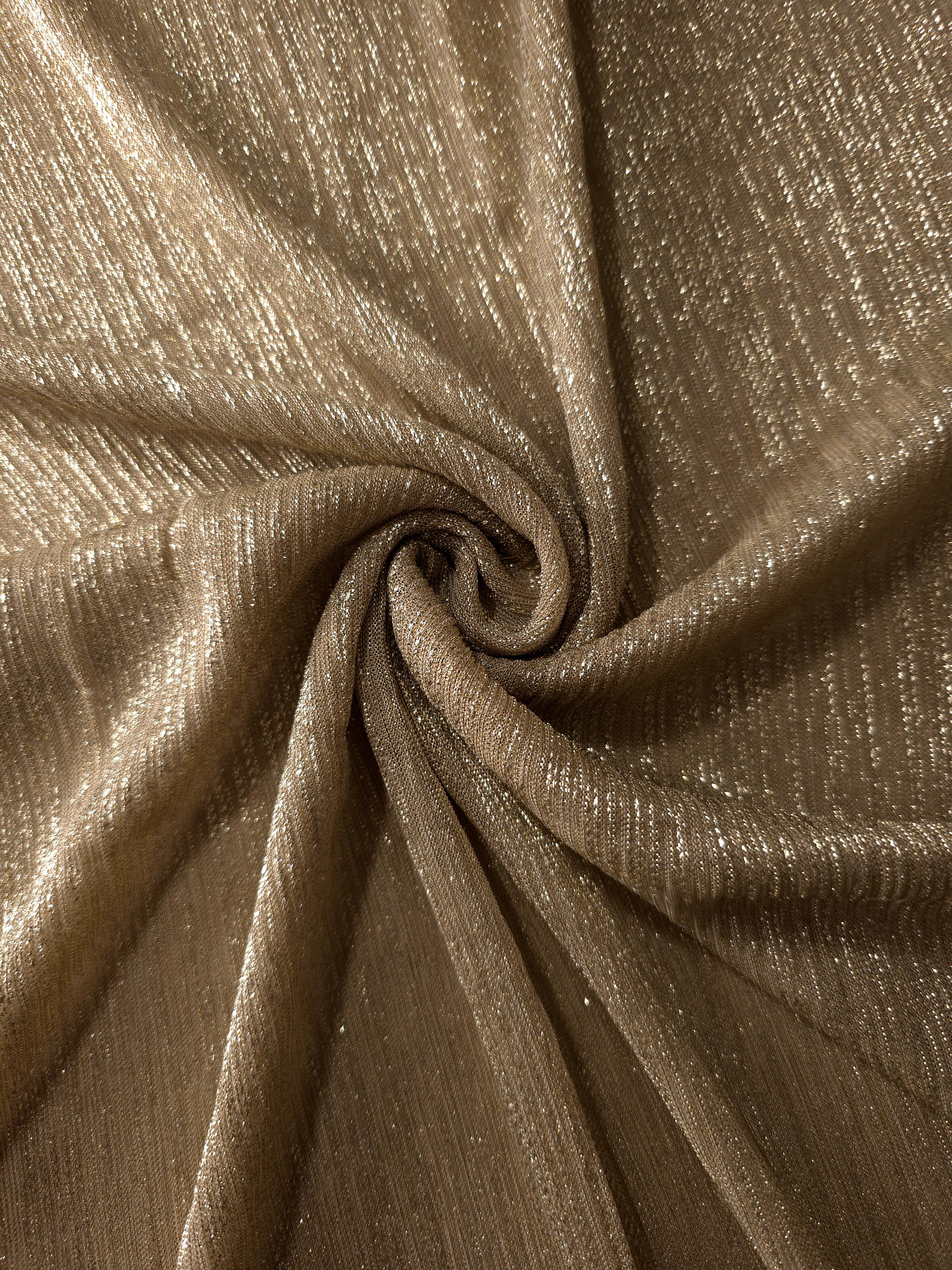 Swirl-draped Antique Taupe Gold Sheer Metallic Shimmer Stretch Tulle Fabric showing fluid movement, reflective shimmer, airy transparency and flexible stretch for dresses, dancewear and stage looks