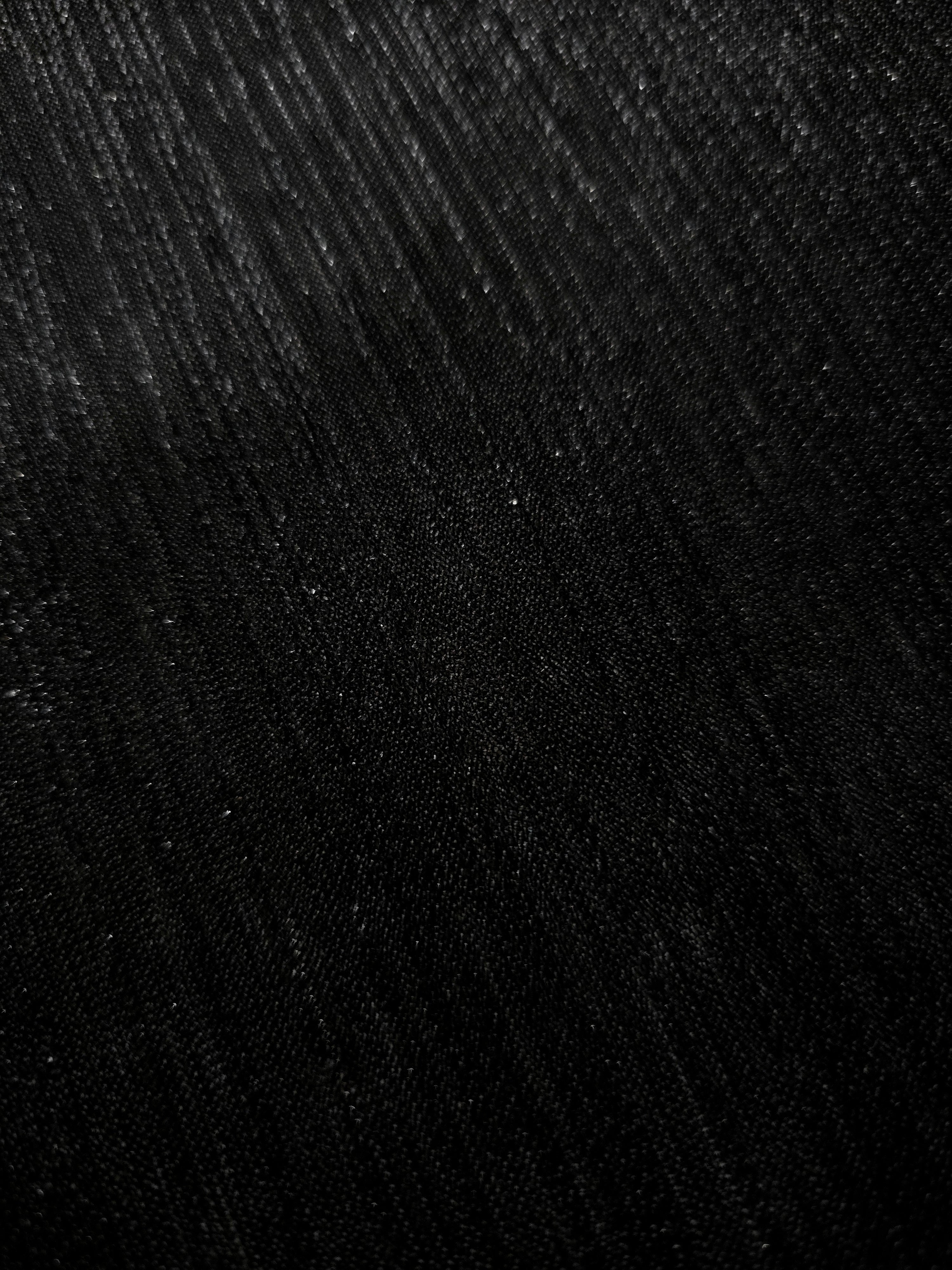Close-up of Charcoal Black Sheer Metallic Shimmer Stretch Tulle Fabric highlighting fine sheer mesh texture, metallic shimmer, lightweight stretch and subtle transparency for fashion and performance wear