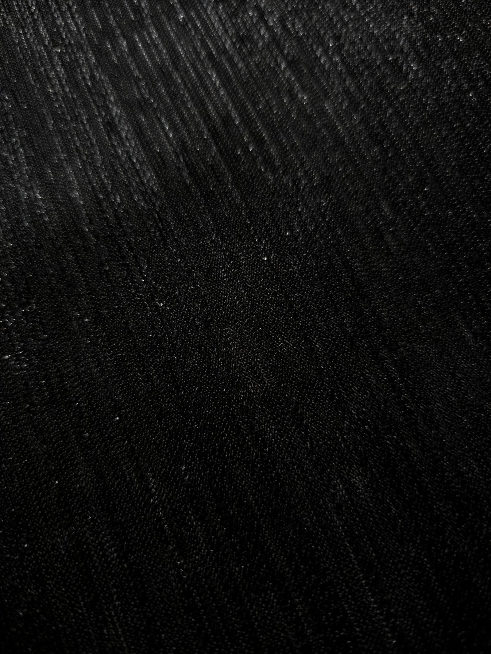 Close-up of Charcoal Black Sheer Metallic Shimmer Stretch Tulle Fabric highlighting fine sheer mesh texture, metallic shimmer, lightweight stretch and subtle transparency for fashion and performance wear