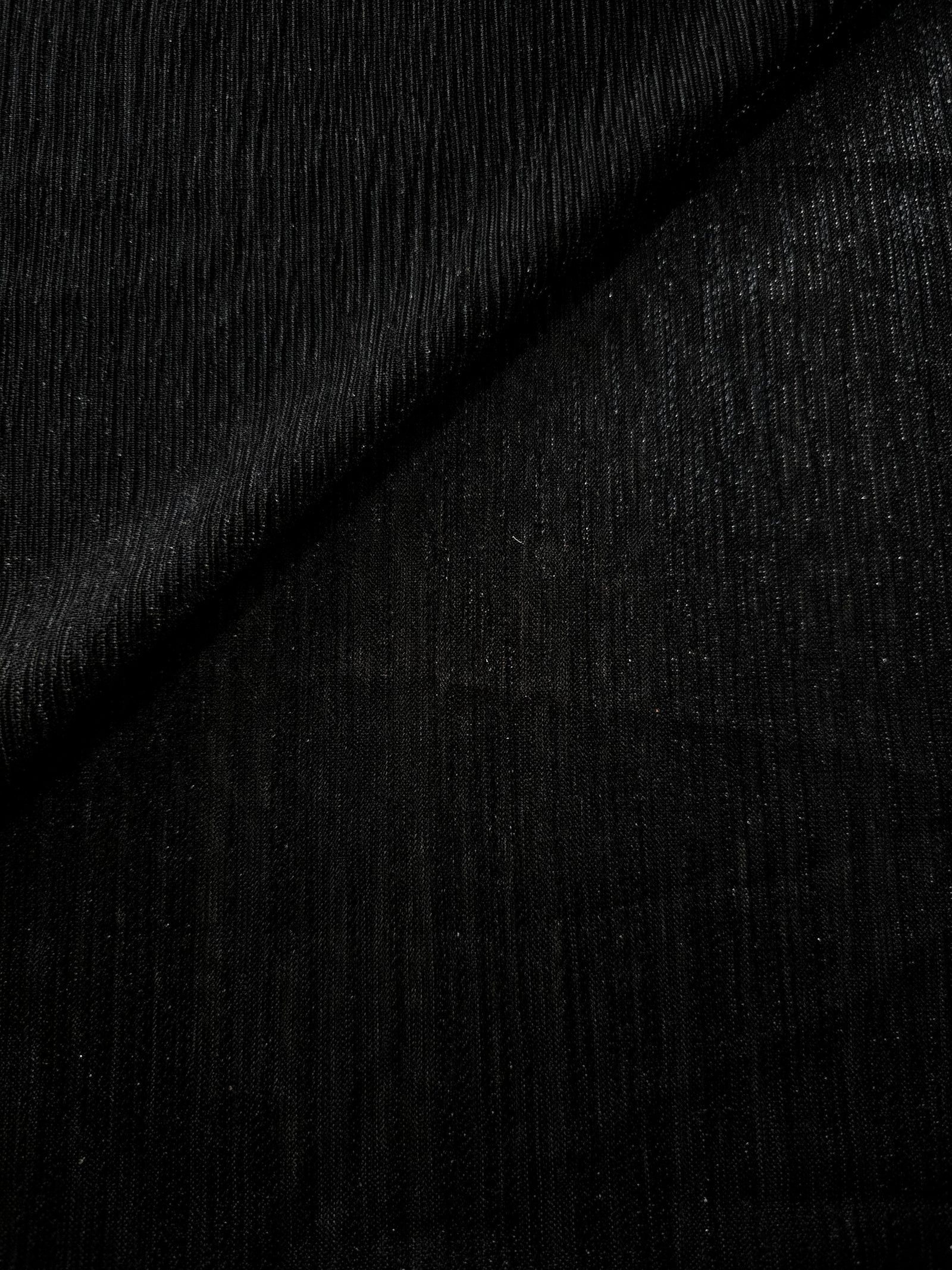 Charcoal Black Sheer Metallic Shimmer Stretch Tulle Fabric shown front and back, revealing reflective metallic shimmer, translucent mesh structure and flexible stretch for layered garments, costumes and dancewear