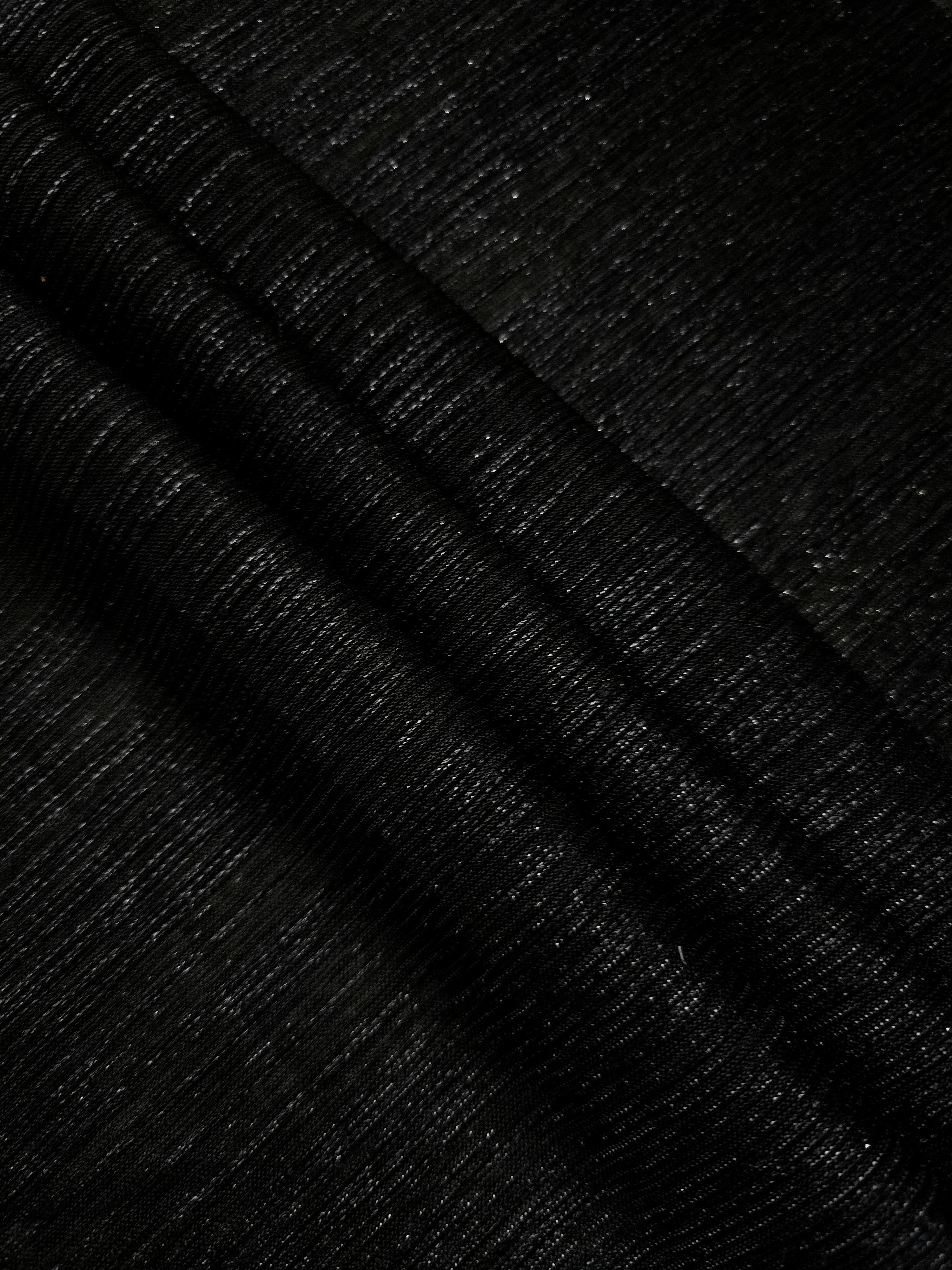 Layered Charcoal Black Sheer Metallic Shimmer Stretch Tulle Fabric showing shimmering depth, soft transparency and airy flexible folds for eveningwear, overlays, costumes and stagewear