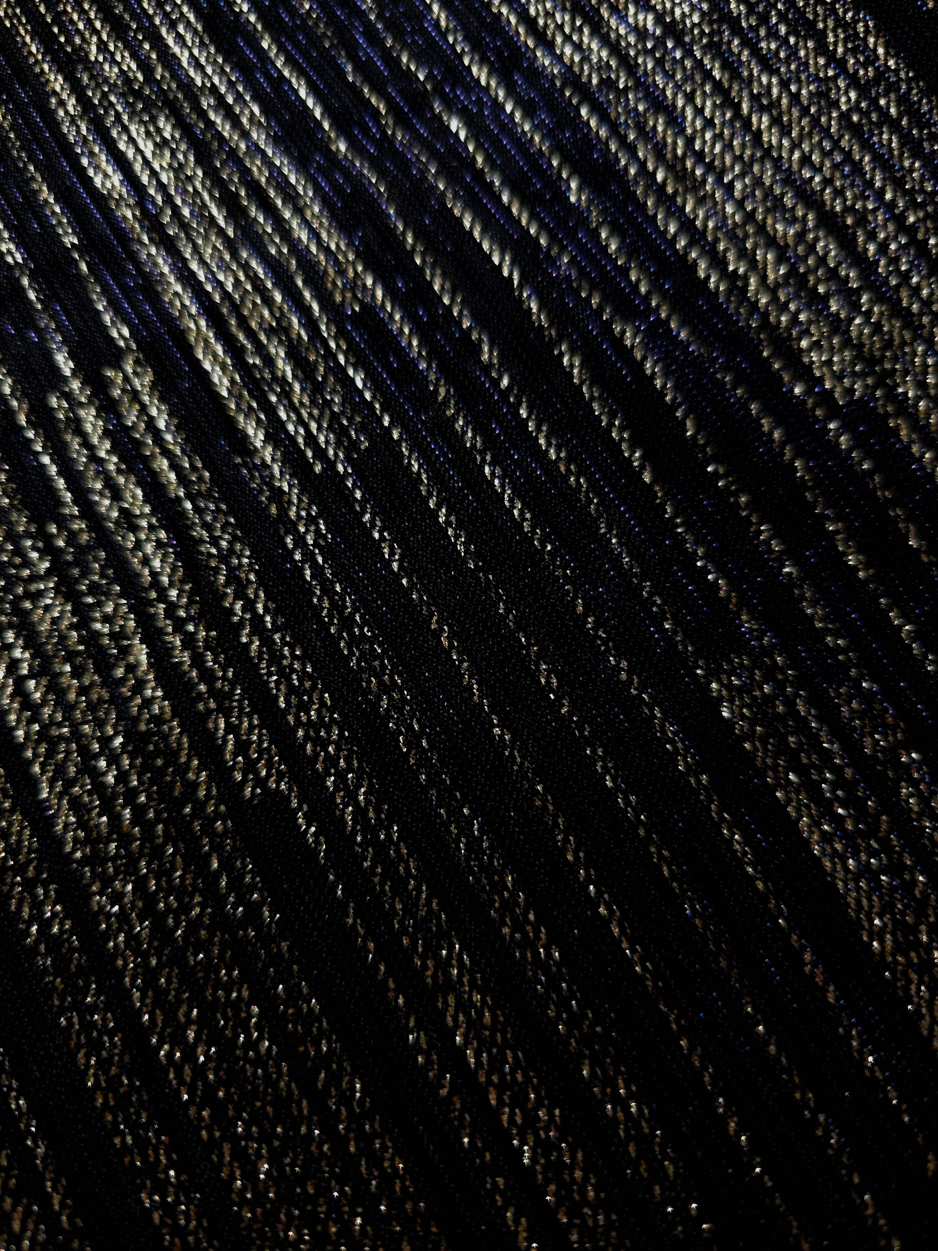 Close-up of Jet Black Sheer Metallic Shimmer Stretch Tulle Fabric highlighting fine sheer mesh texture, metallic shimmer, lightweight stretch and subtle transparency for fashion and performance wear
