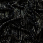 Draped Jet Black Sheer Metallic Shimmer Stretch Tulle Fabric showing luminous reflective folds, soft transparency and flexible flow for dresses, dancewear, stagewear and occasion looks