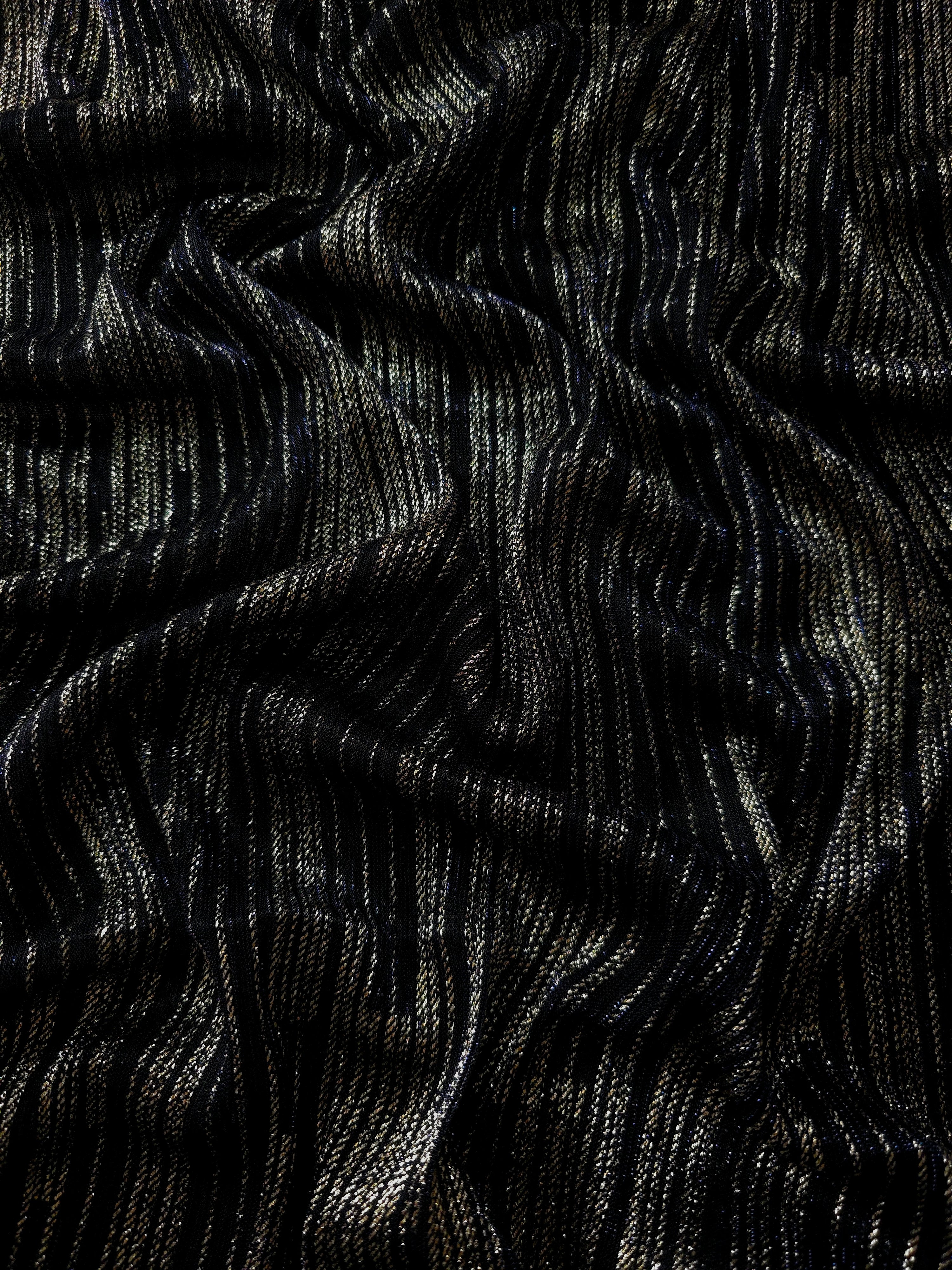 Draped Jet Black Sheer Metallic Shimmer Stretch Tulle Fabric showing luminous reflective folds, soft transparency and flexible flow for dresses, dancewear, stagewear and occasion looks