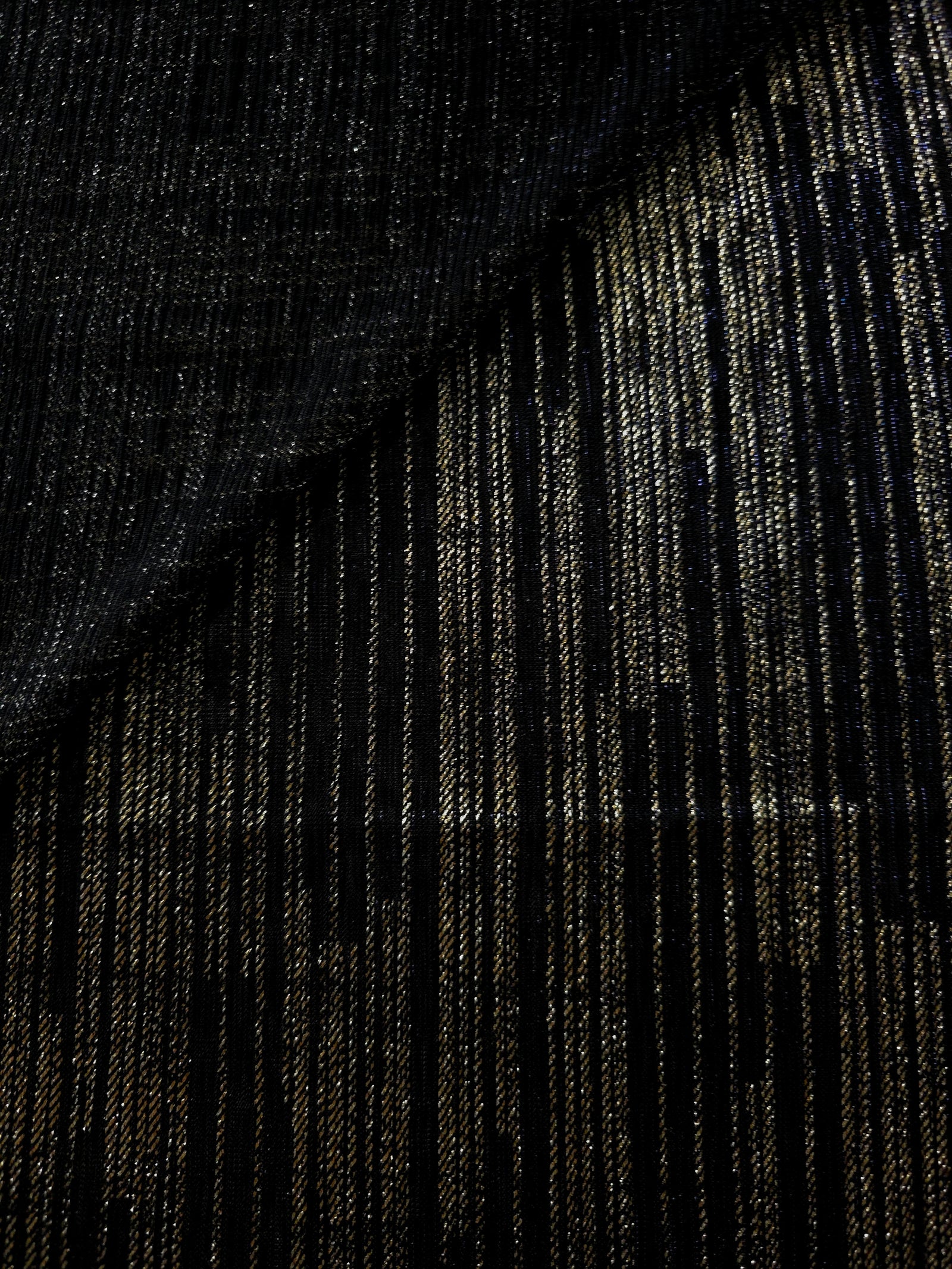 Jet Black Sheer Metallic Shimmer Stretch Tulle Fabric shown front and back, revealing reflective metallic shimmer, translucent mesh structure and flexible stretch for layered garments, costumes and dancewear