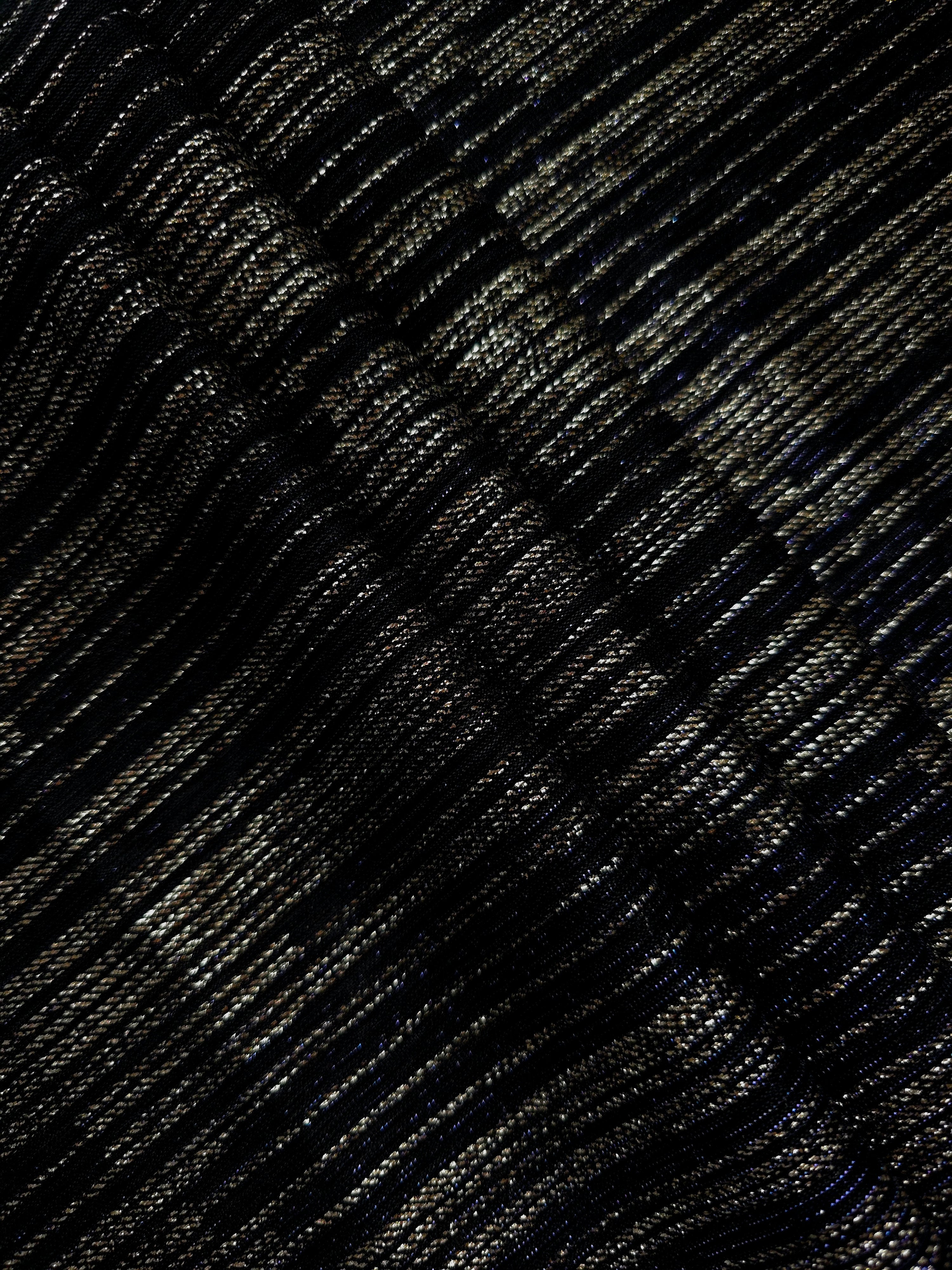 Layered Jet Black Sheer Metallic Shimmer Stretch Tulle Fabric showing shimmering depth, soft transparency and airy flexible folds for eveningwear, overlays, costumes and stagewear