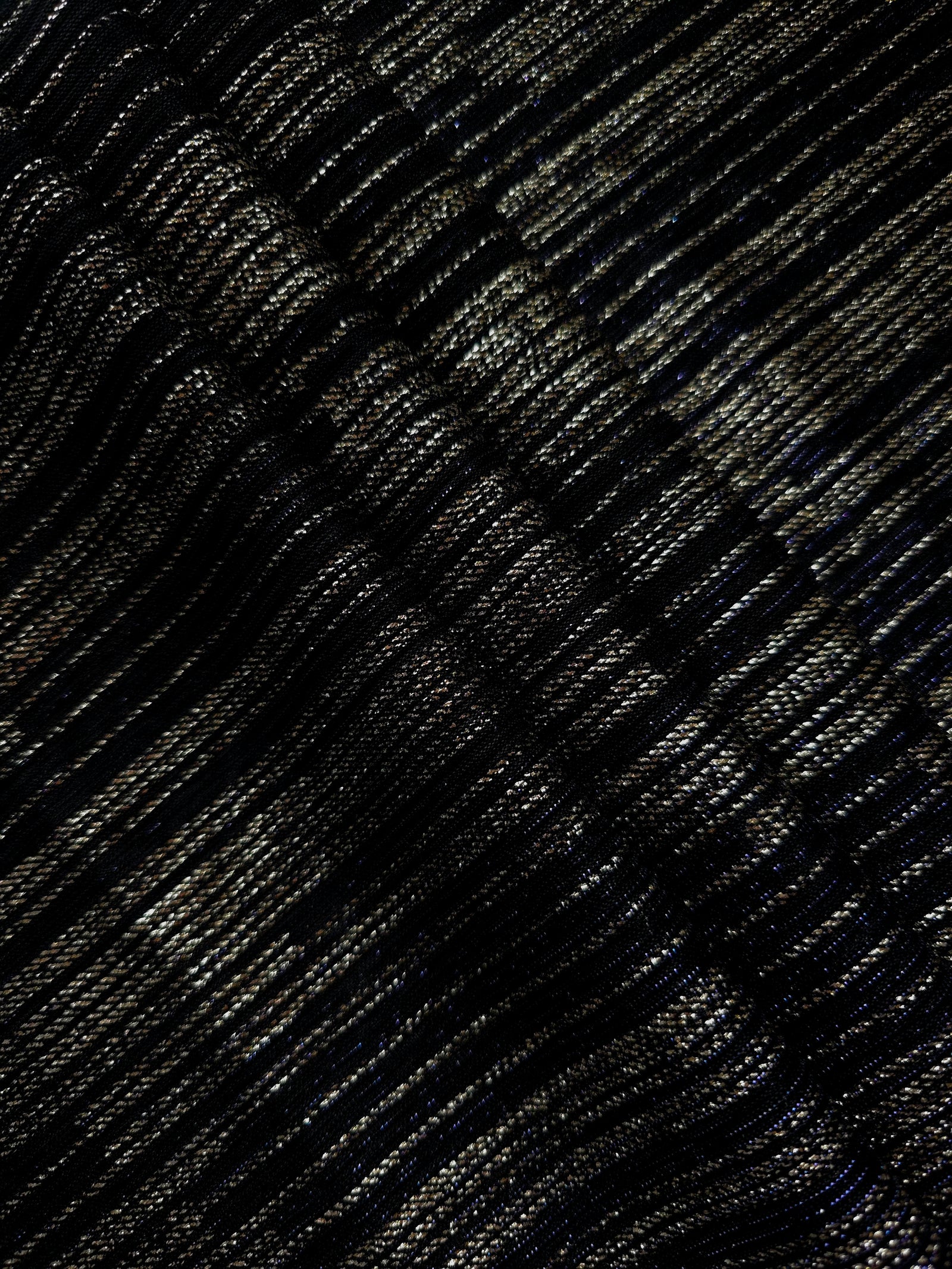 Layered Jet Black Sheer Metallic Shimmer Stretch Tulle Fabric showing shimmering depth, soft transparency and airy flexible folds for eveningwear, overlays, costumes and stagewear