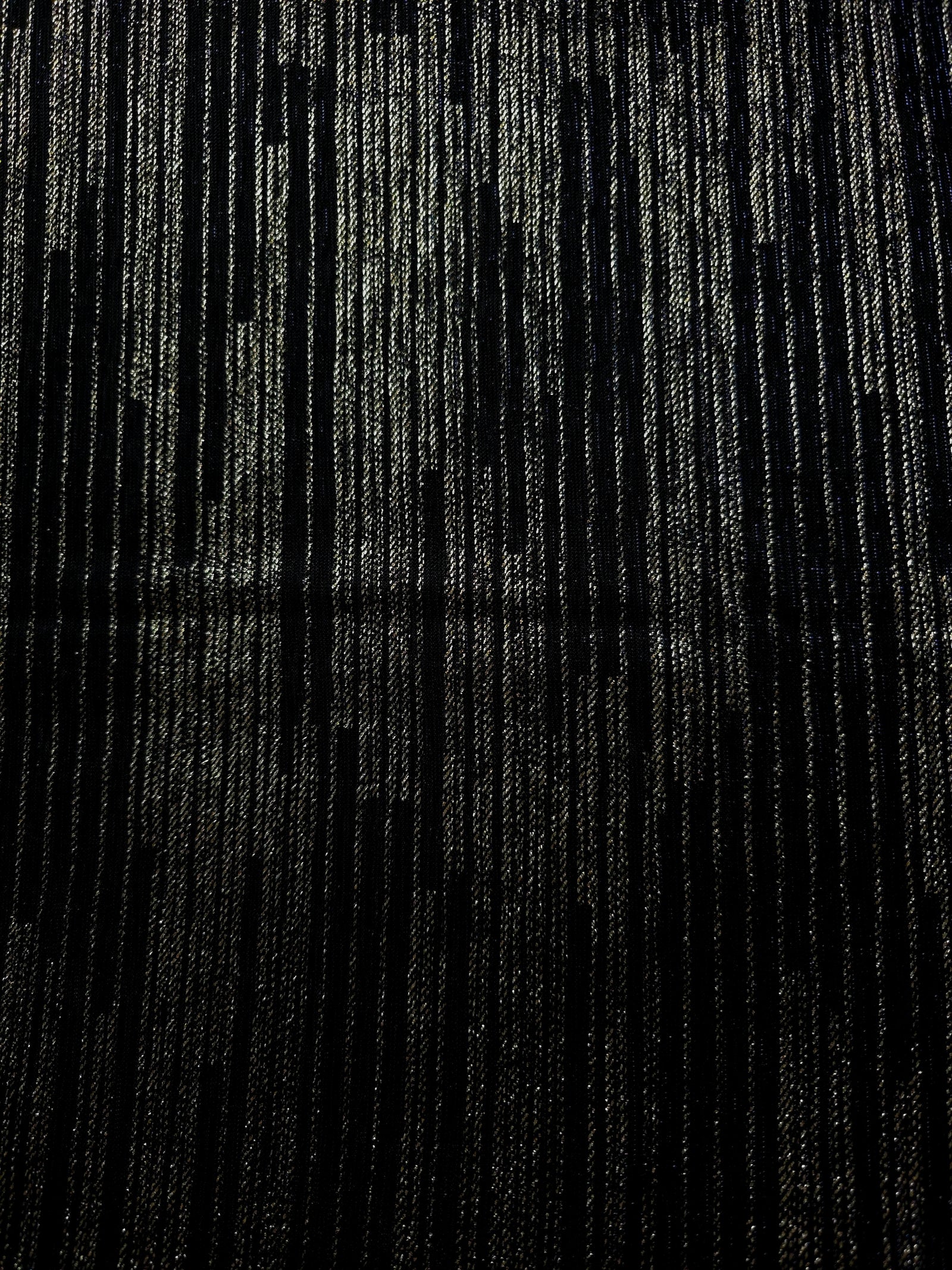 Surface view of Jet Black Sheer Metallic Shimmer Stretch Tulle Fabric showing even metallic shimmer, fine sheer tulle texture, translucent finish and stretch for overlays, dresses and performance wear