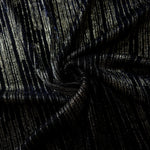 Swirl-draped Jet Black Sheer Metallic Shimmer Stretch Tulle Fabric showing fluid movement, reflective shimmer, airy transparency and flexible stretch for dresses, dancewear and stage looks