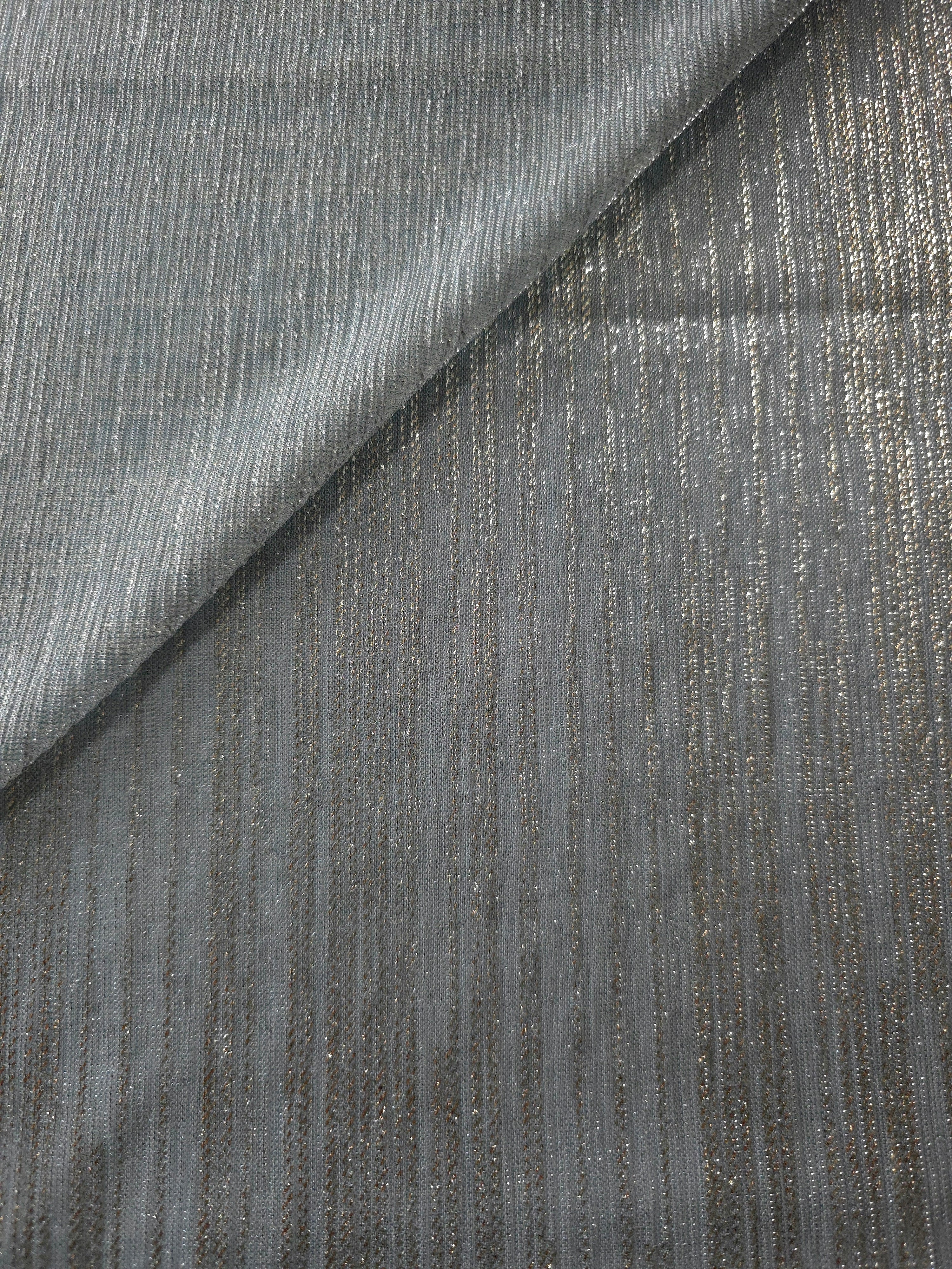 Pewter Gray Sheer Metallic Shimmer Stretch Tulle Fabric shown front and back, revealing reflective metallic shimmer, translucent mesh structure and flexible stretch for layered garments, costumes and dancewear