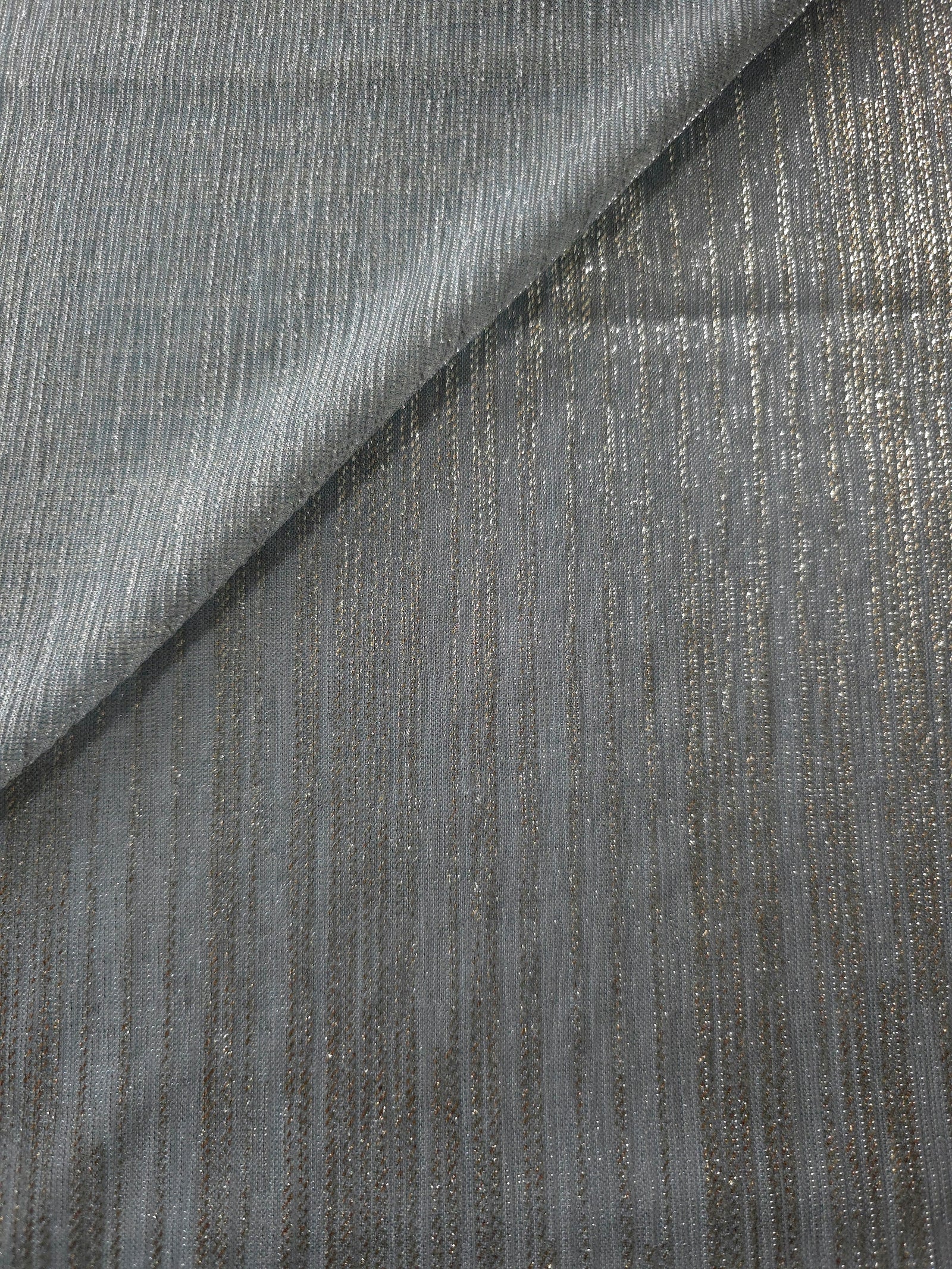 Pewter Gray Sheer Metallic Shimmer Stretch Tulle Fabric shown front and back, revealing reflective metallic shimmer, translucent mesh structure and flexible stretch for layered garments, costumes and dancewear