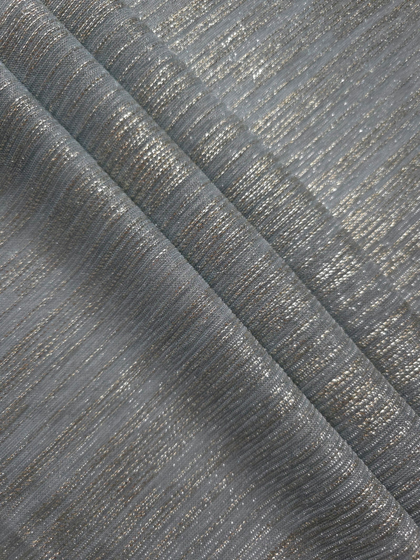 Layered Pewter Gray Sheer Metallic Shimmer Stretch Tulle Fabric showing shimmering depth, soft transparency and airy flexible folds for eveningwear, overlays, costumes and stagewear