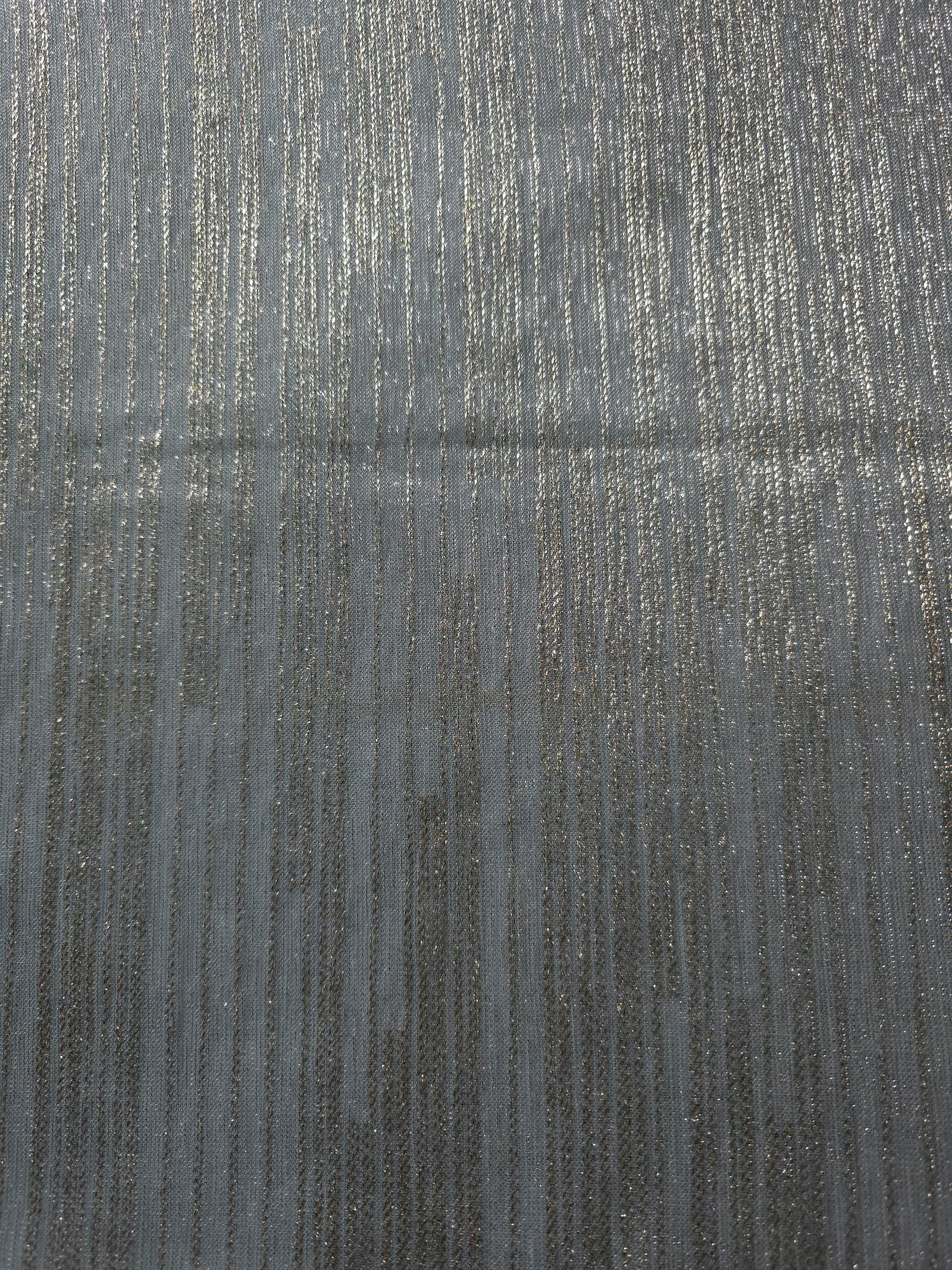 Surface view of Pewter Gray Sheer Metallic Shimmer Stretch Tulle Fabric showing even metallic shimmer, fine sheer tulle texture, translucent finish and stretch for overlays, dresses and performance wear